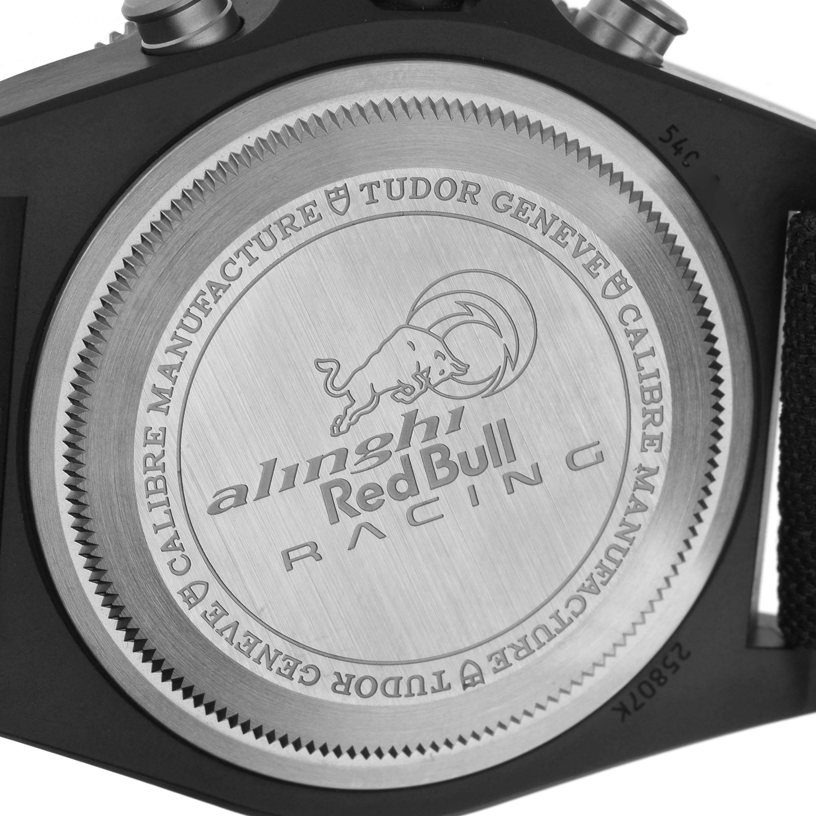 The image shows the case back of a Tudor Pelagos M25807KN Men's Ceramic Blue Dial watch with "Alinghi Red Bull Racing" engraving.