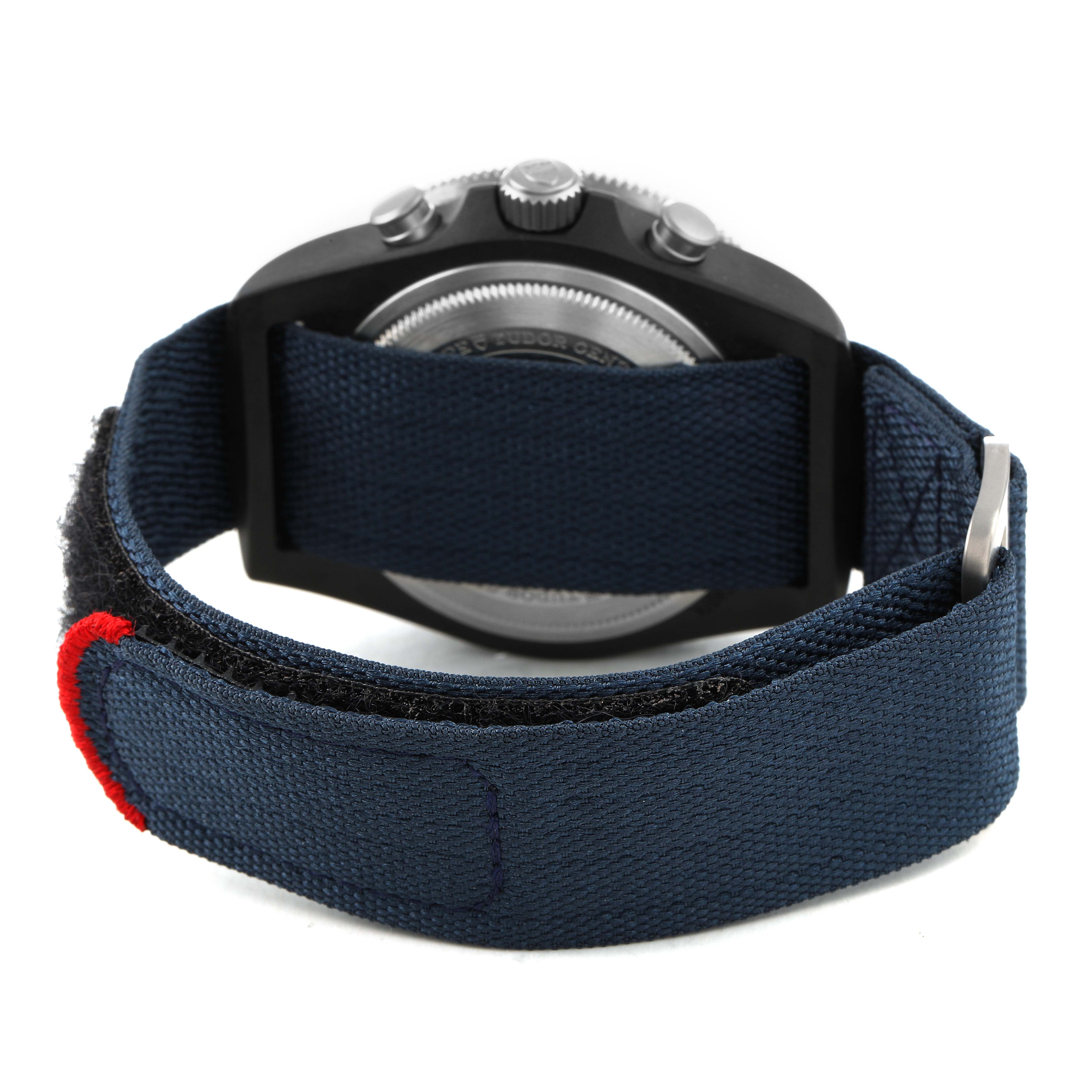 The Tudor Pelagos M25807KN Men's Ceramic Blue Dial watch is shown from the back, highlighting its fabric strap and caseback.