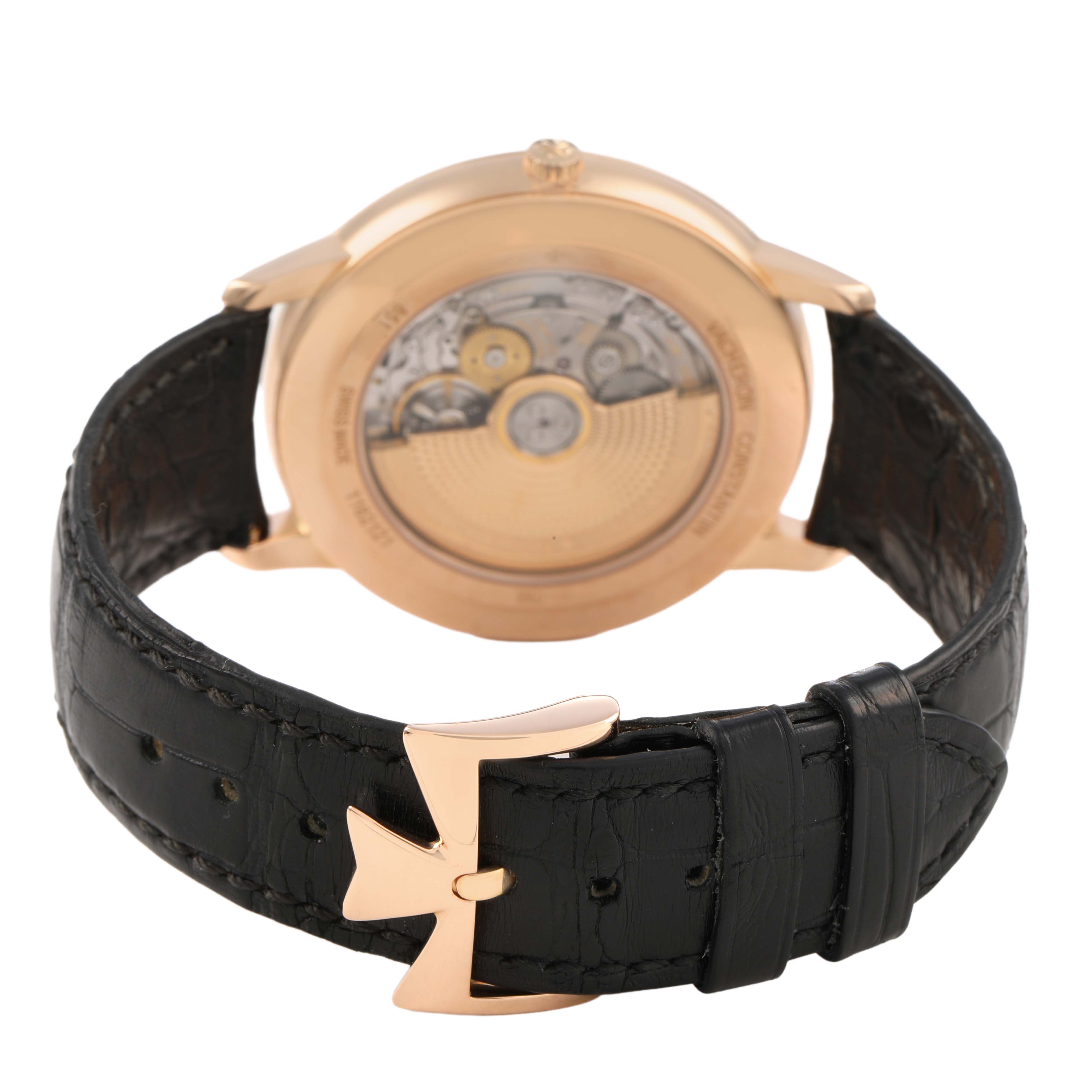 The image shows the back of the Vacheron Constantin Patrimony 85180/000R-9232 Men's Rose Gold Black Dial watch, highlighting the mechanical movement and the strap's buckle.