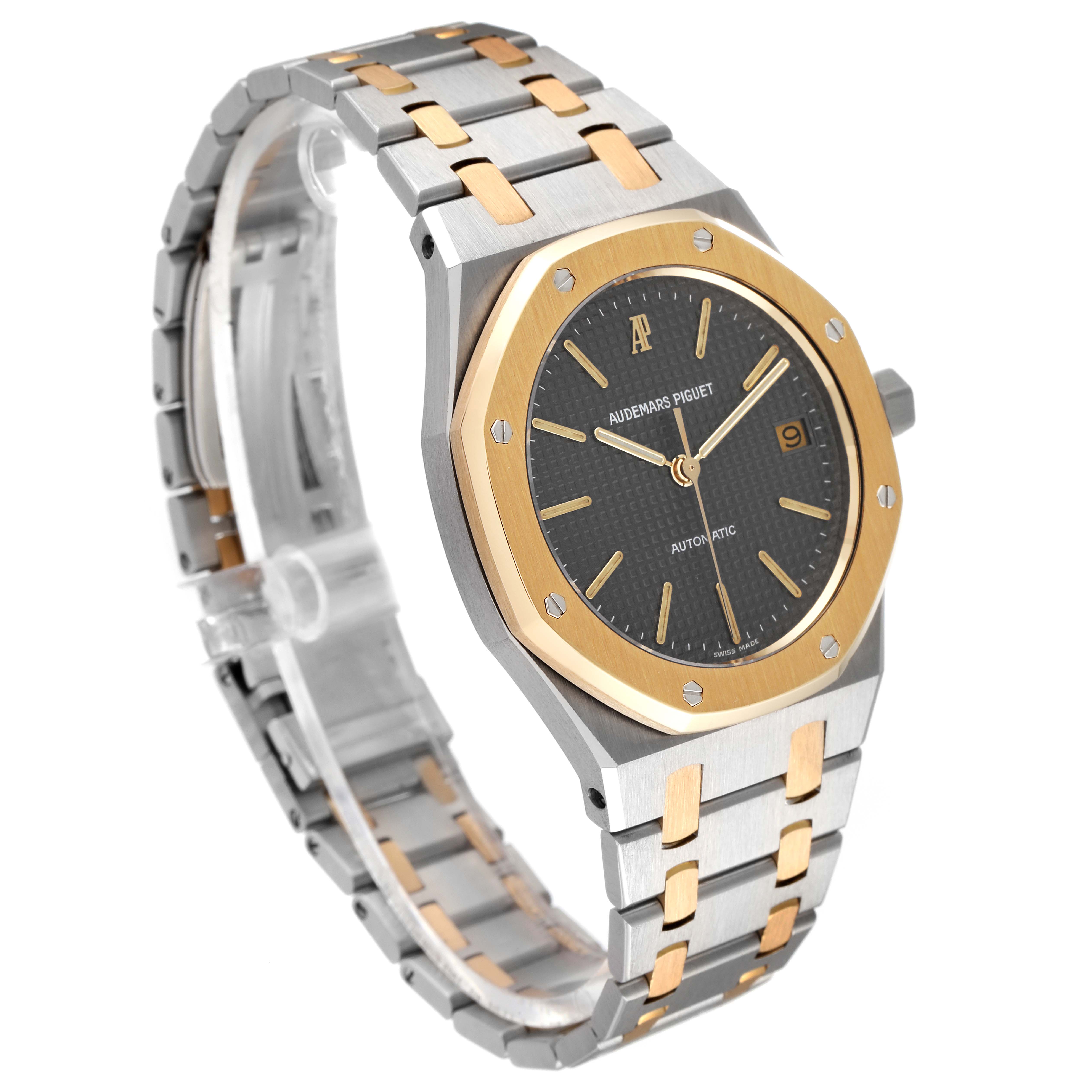 This image shows an oblique view of the Royal Oak by Audemars Piguet revealing the face, bezel, crown, and two-tone bracelet.