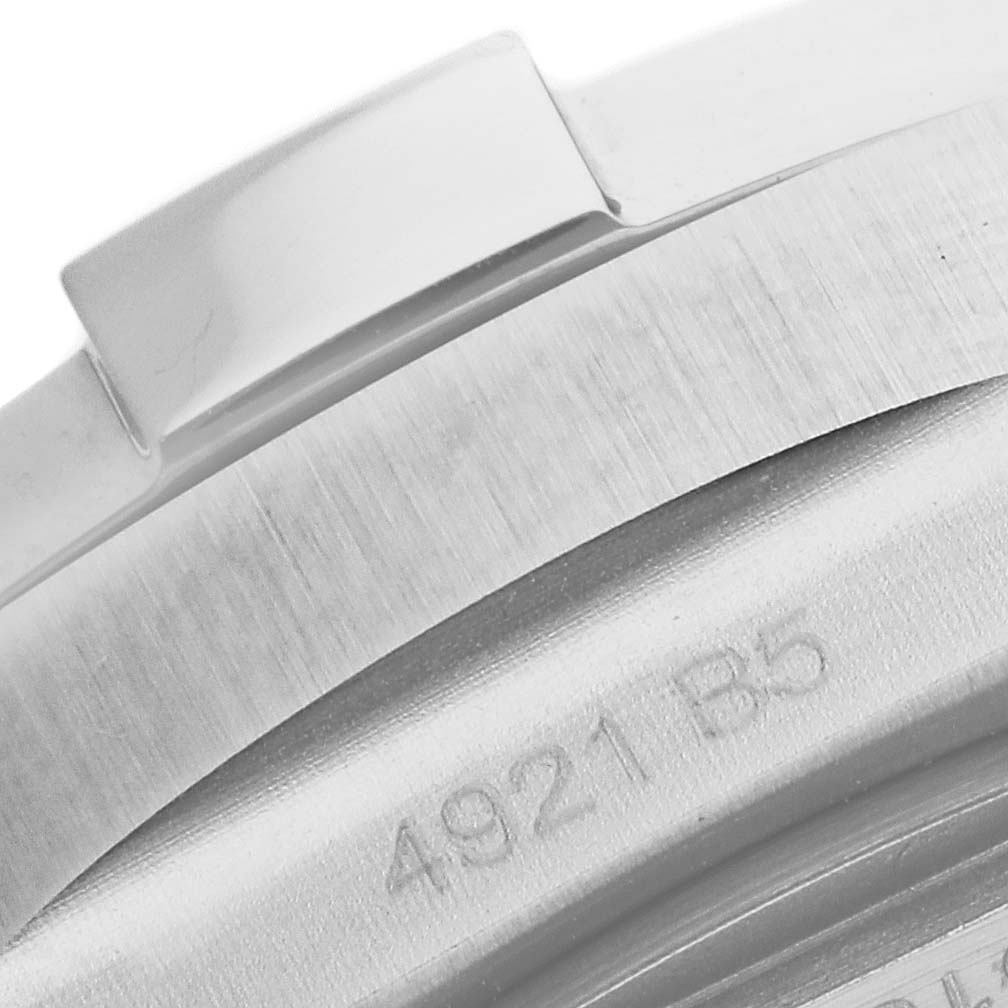 The image shows a close-up view of the side of the Breitling Avenger A17318 Men's Stainless Steel Black Dial A17318 Men's Stainless Steel Black Dial watch casing, highlighting its brushed metal finish and engraved markings.