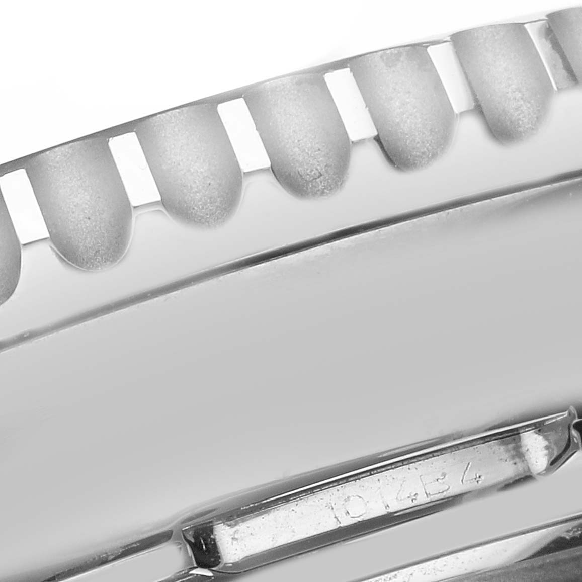 This image shows a close-up of the textured bezel and part of the case of a Breitling Navitimer AB0441 Men
s Stainless Steel Black Dial AB0441 Men
s Stainless Steel Black Dial watch.