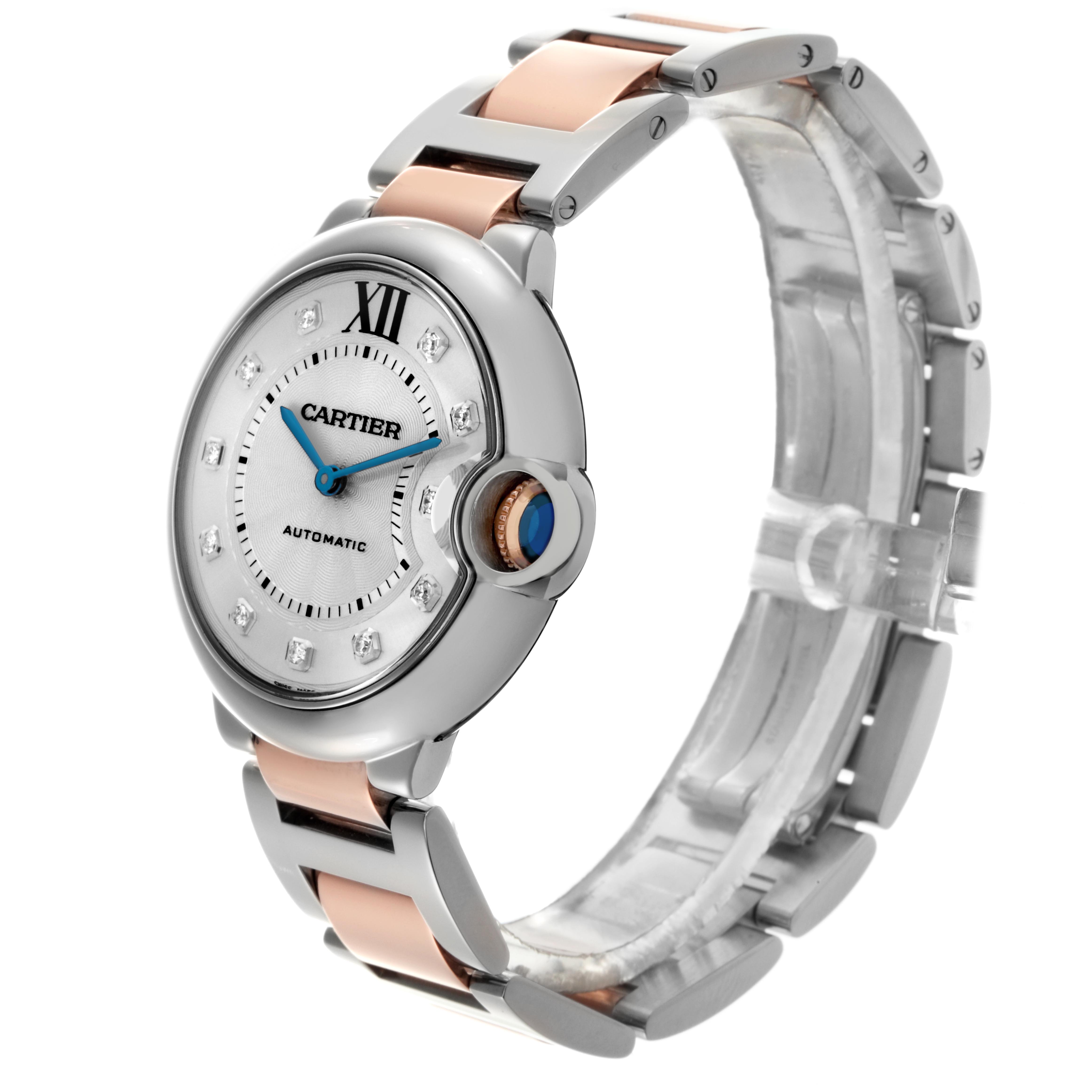 The Ballon Bleu de Cartier watch is shown at a slight angle displaying the face, crown with a blue cabochon, and part of the bracelet.