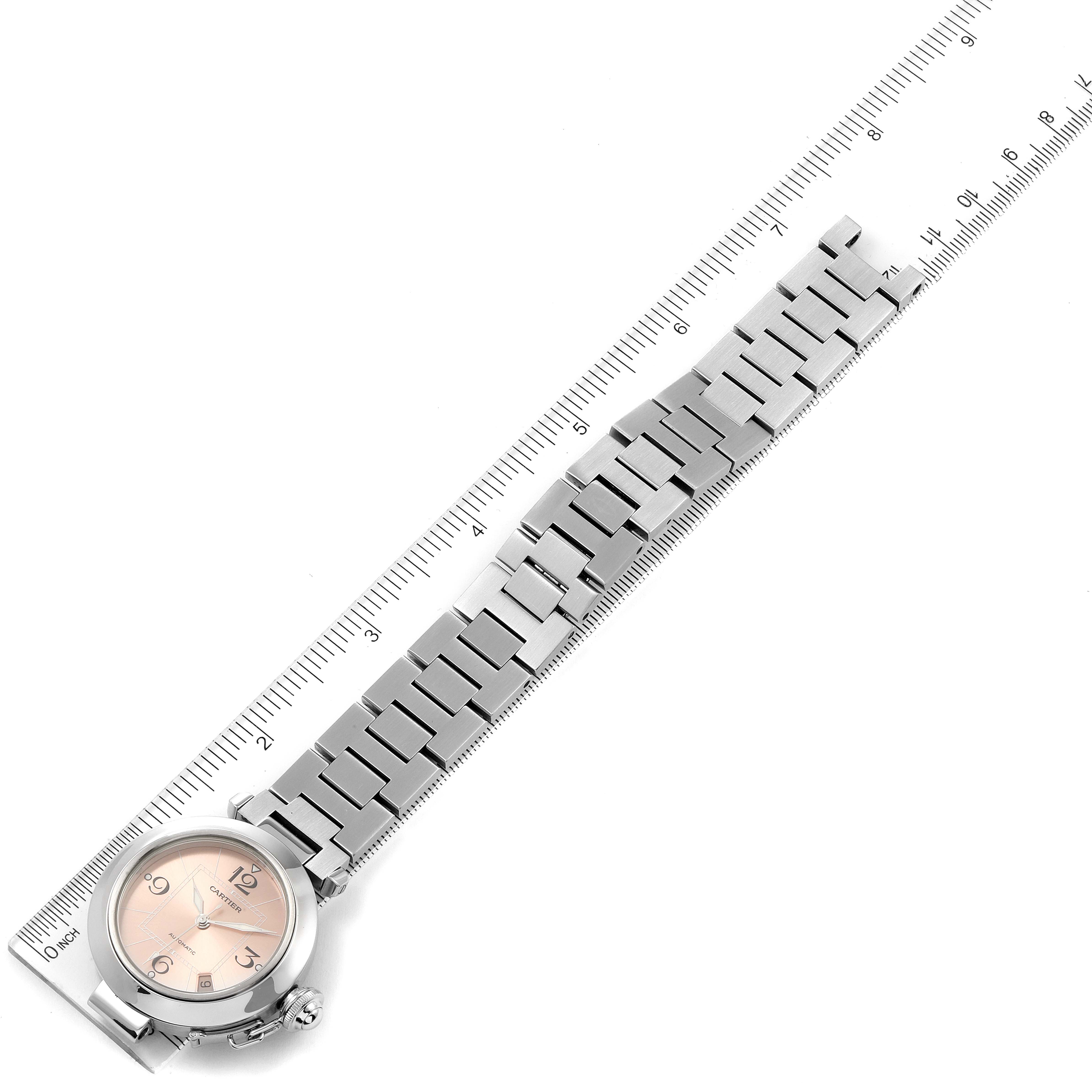 This image shows a Cartier Pasha W31075M7 Women's Stainless Steel Pink Dial W31075M7 Women's Stainless Steel Pink Dial watch from a top-down angle, highlighting the entire watch including the metal bracelet and dial.