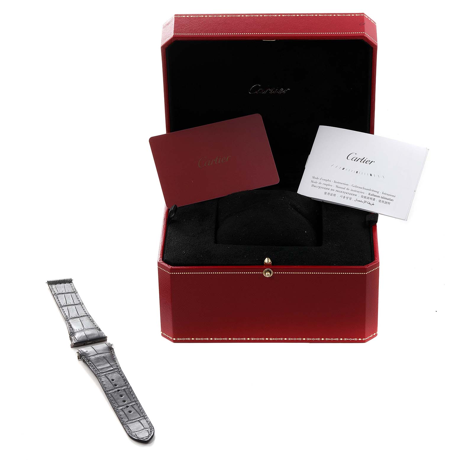 Photographed at an angle, this Cartier Santos WGSA0017 Men's Rose Gold Silver Dial WGSA0017 Men's Rose Gold Silver Dial watch box includes documents and an extra strap placed beside it.