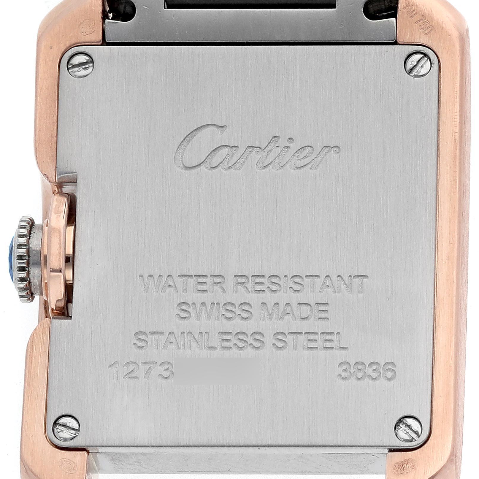 The image shows the back of a Cartier Tank Anglaise W3TA0002 Women
s Steel and Gold (two tone) Silver Dial W3TA0002 Women
s Steel and Gold (two tone) Silver Dial watch, displaying its screws, crown, and engravings.