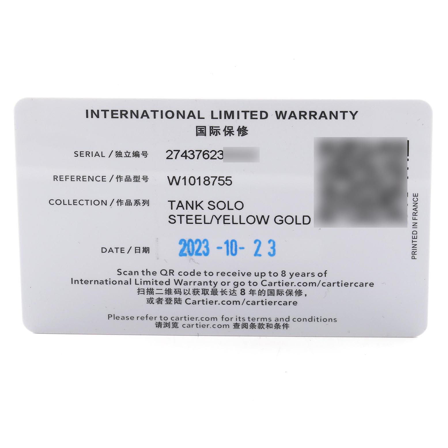 The image shows an International Limited Warranty card for the Cartier Tank Solo W1018755 Women
s Steel and Gold (two tone) Silver Dial W1018755 Women
s Steel and Gold (two tone) Silver Dial watch, displaying serial and reference numbers.