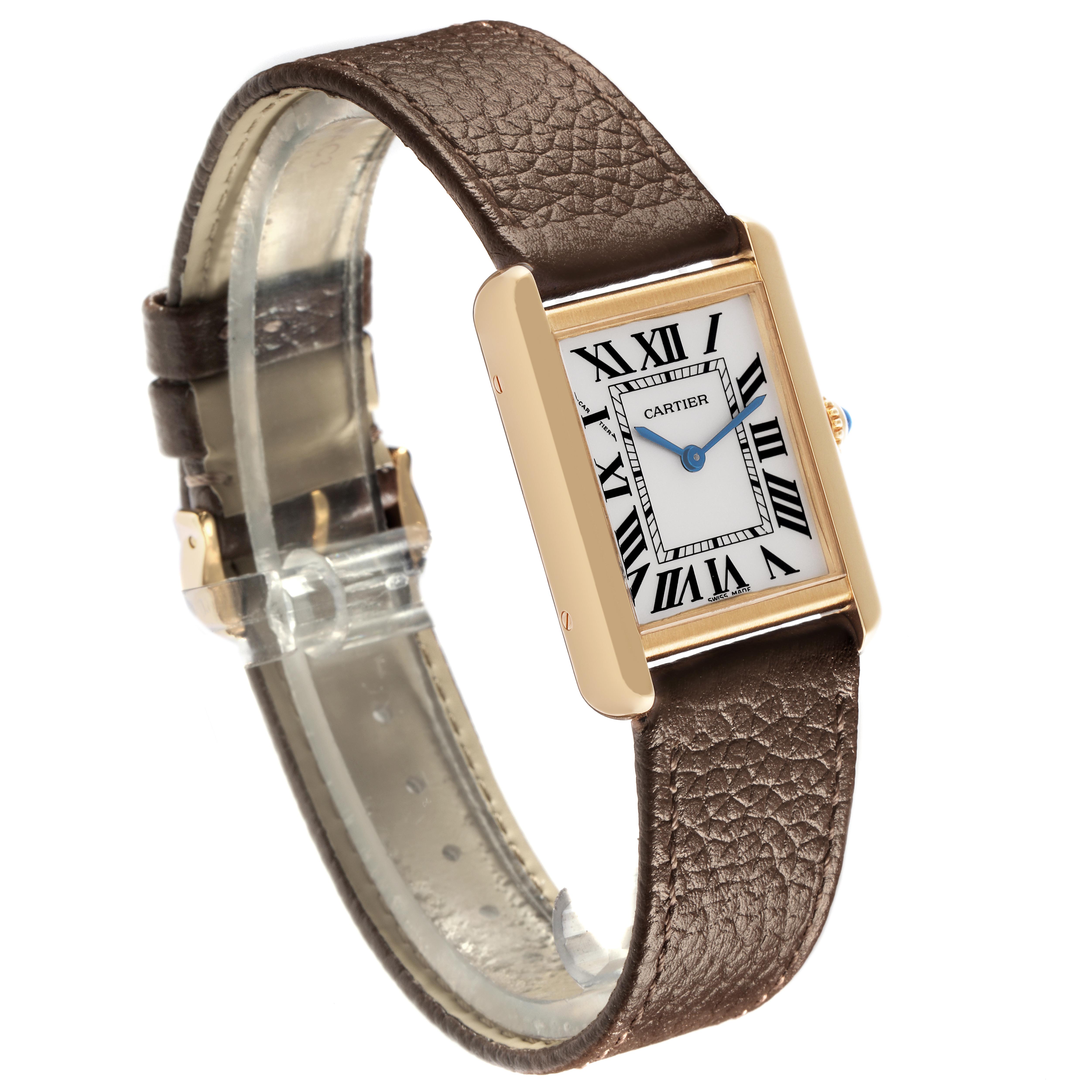 The Cartier Tank Solo W1018755 Women
s Steel and Gold (two tone) Silver Dial W1018755 Women
s Steel and Gold (two tone) Silver Dial watch is shown at an angled side view, displaying the face, brown leather strap, and gold rectangular case.