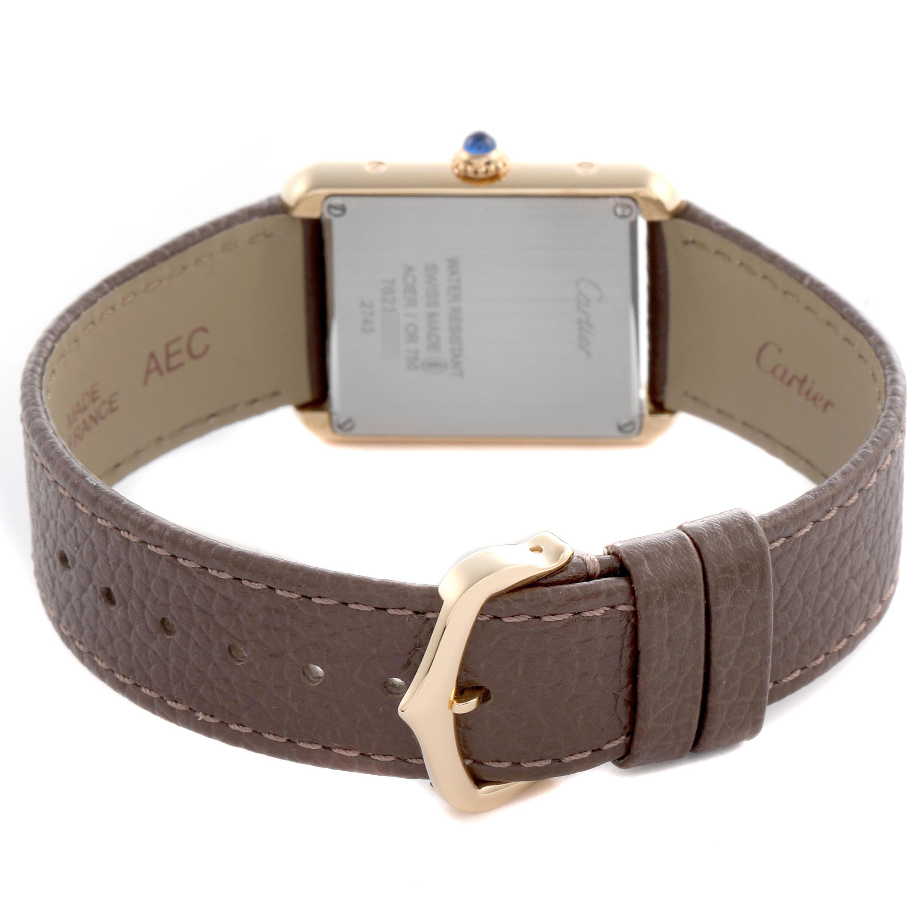 The image shows the back view of a Cartier Tank Solo W1018755 Women
s Steel and Gold (two tone) Silver Dial W1018755 Women
s Steel and Gold (two tone) Silver Dial watch, highlighting the case back, leather strap, and buckle.