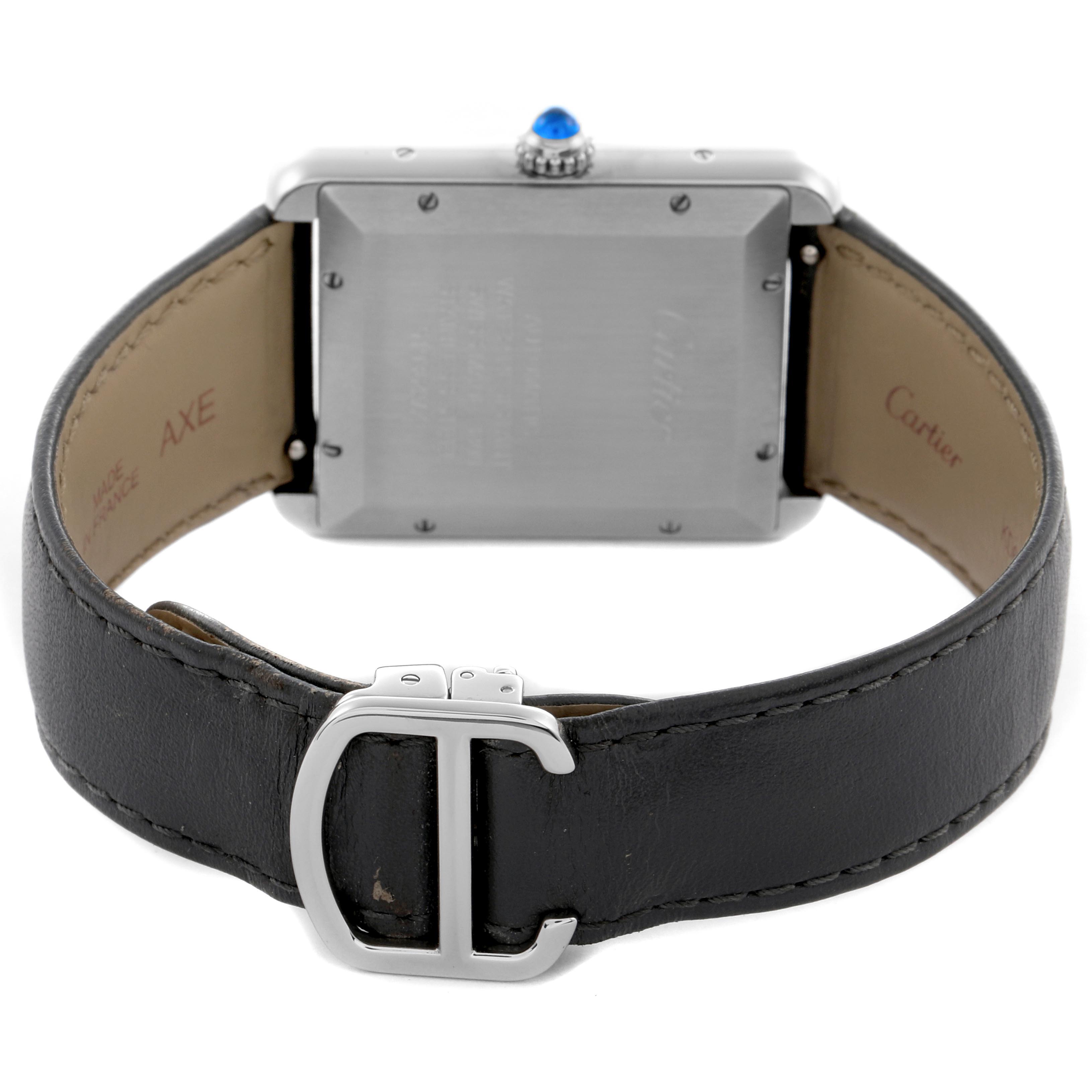 The image shows the back view of the Tank Solo by Cartier, highlighting the buckle, strap, case back, and crown.