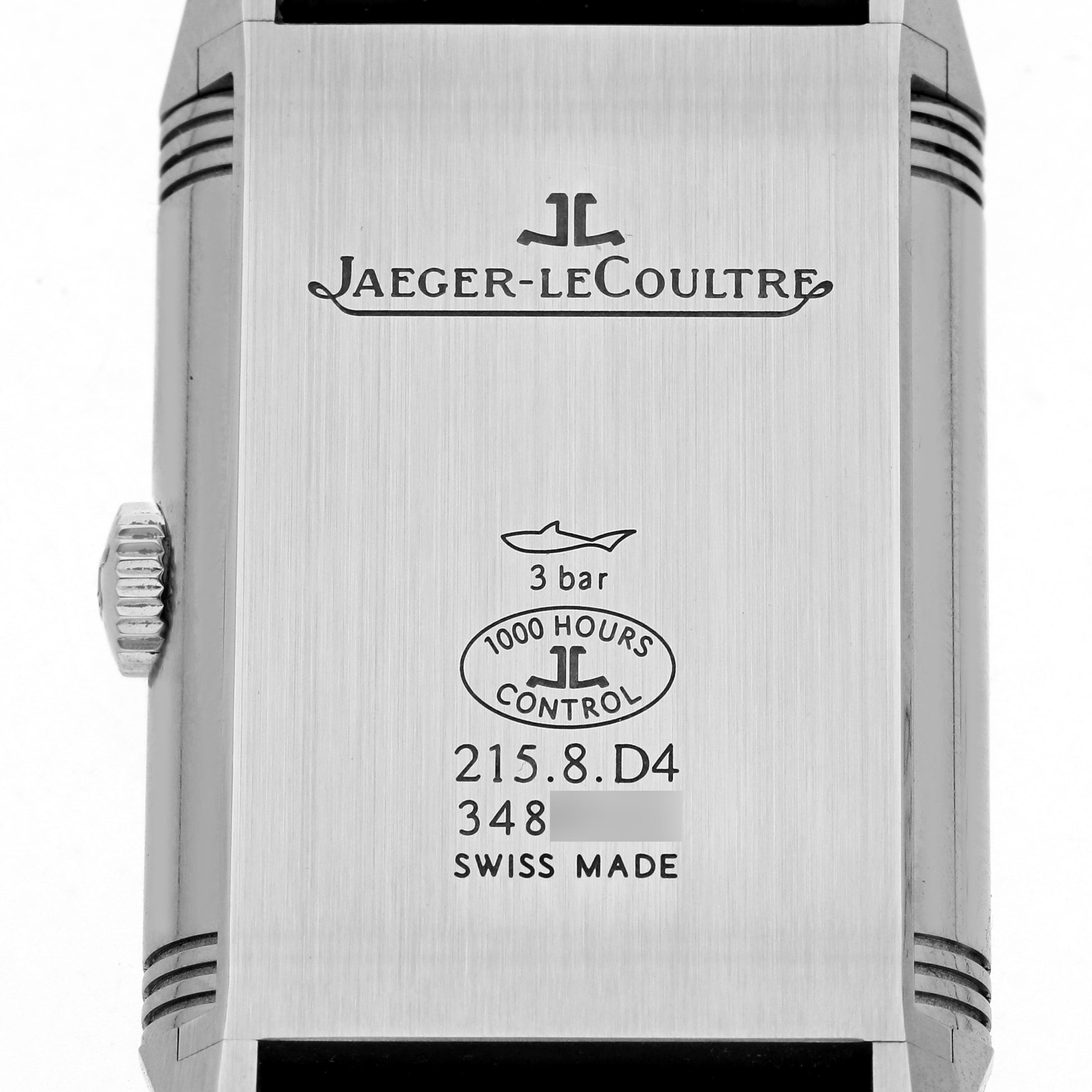 The image shows the back of the Jaeger-LeCoultre Reverso watch, highlighting engravings, logo, and crown.