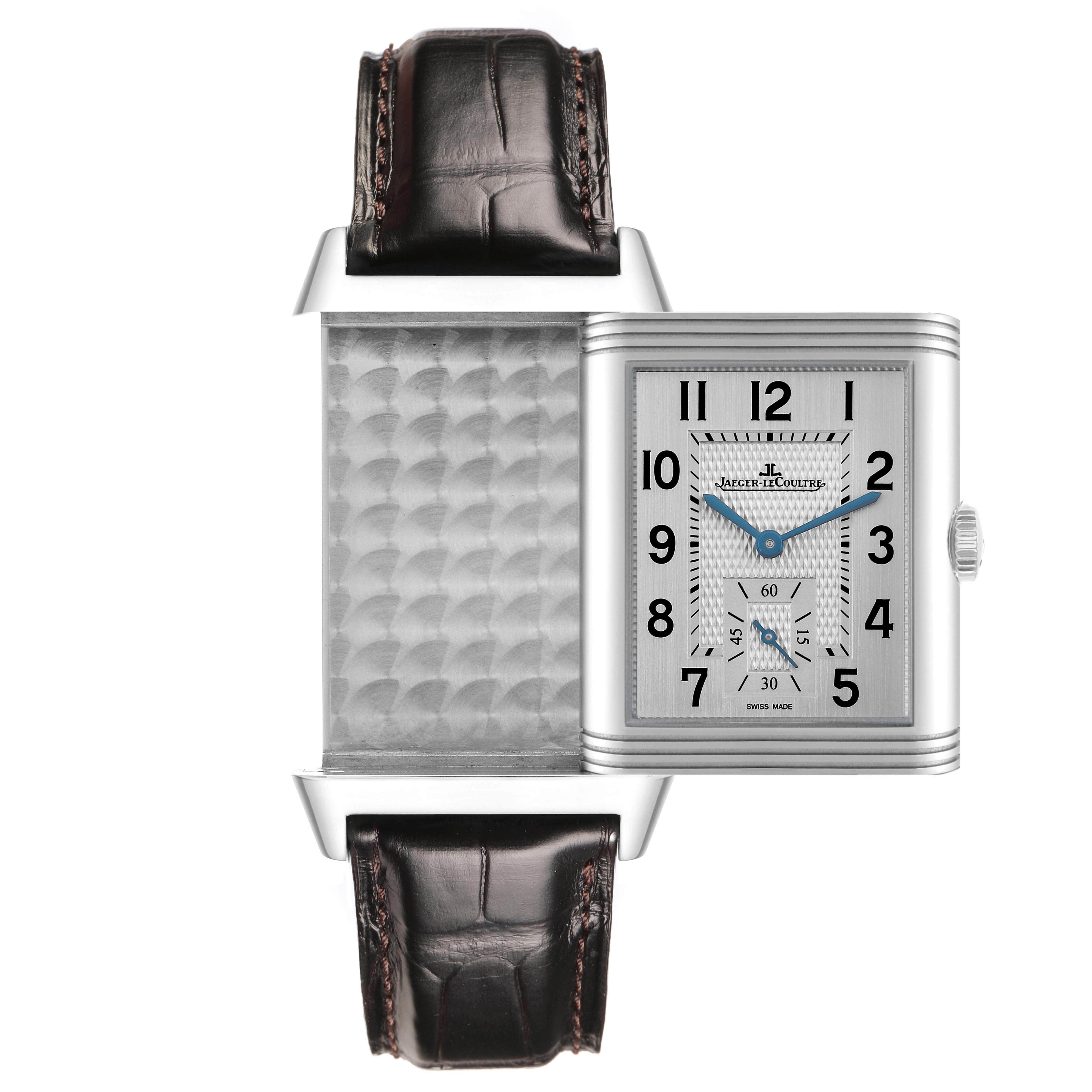The Jaeger-LeCoultre Reverso watch is shown with its face partially flipped to reveal the textured metal back.