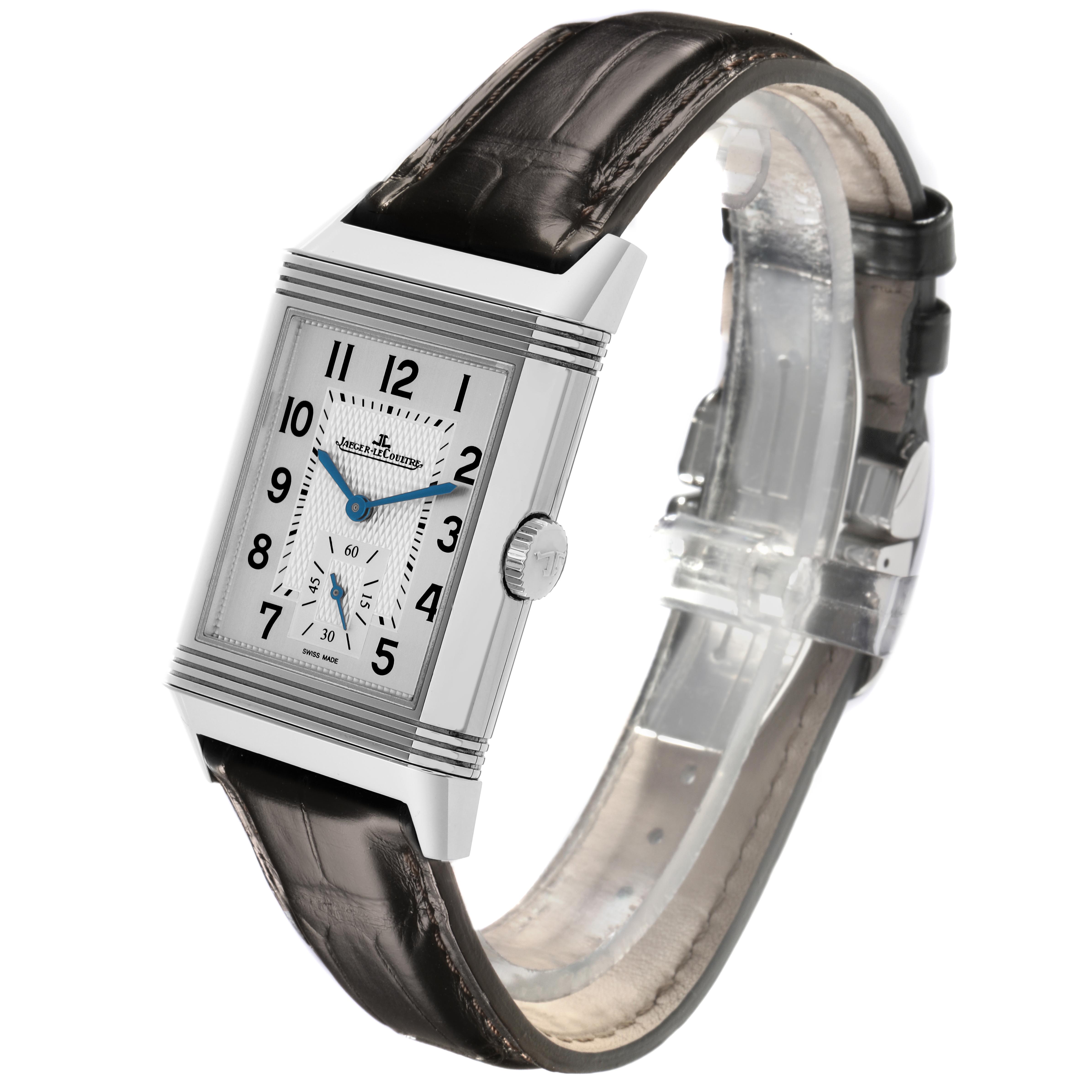 The Reverso by Jaeger-LeCoultre is shown at an angle displaying its rectangular case, crown, dial, and leather strap.