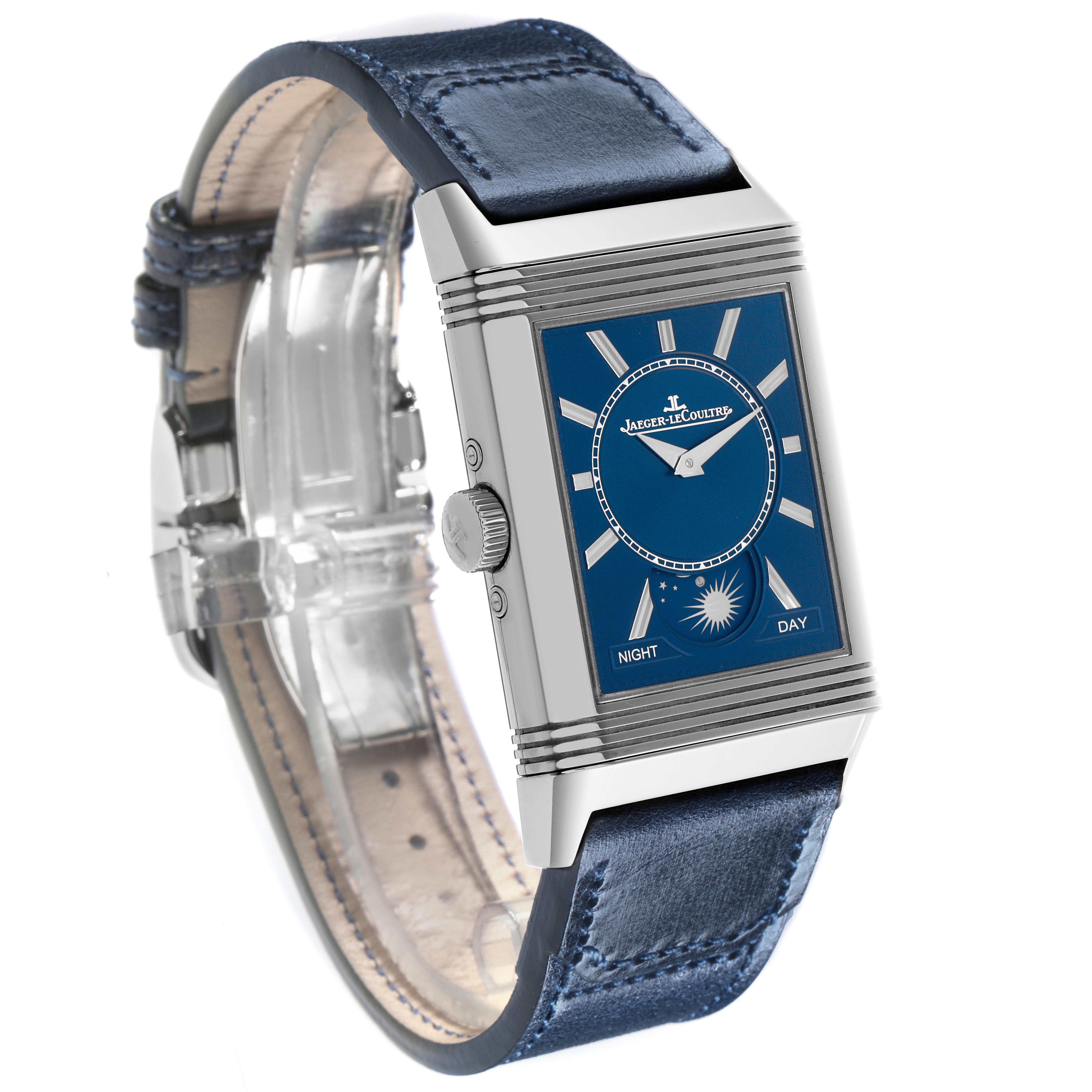 The Jaeger-LeCoultre Reverso watch is shown at a slight angle, displaying its rectangular case, blue dial, and leather strap.