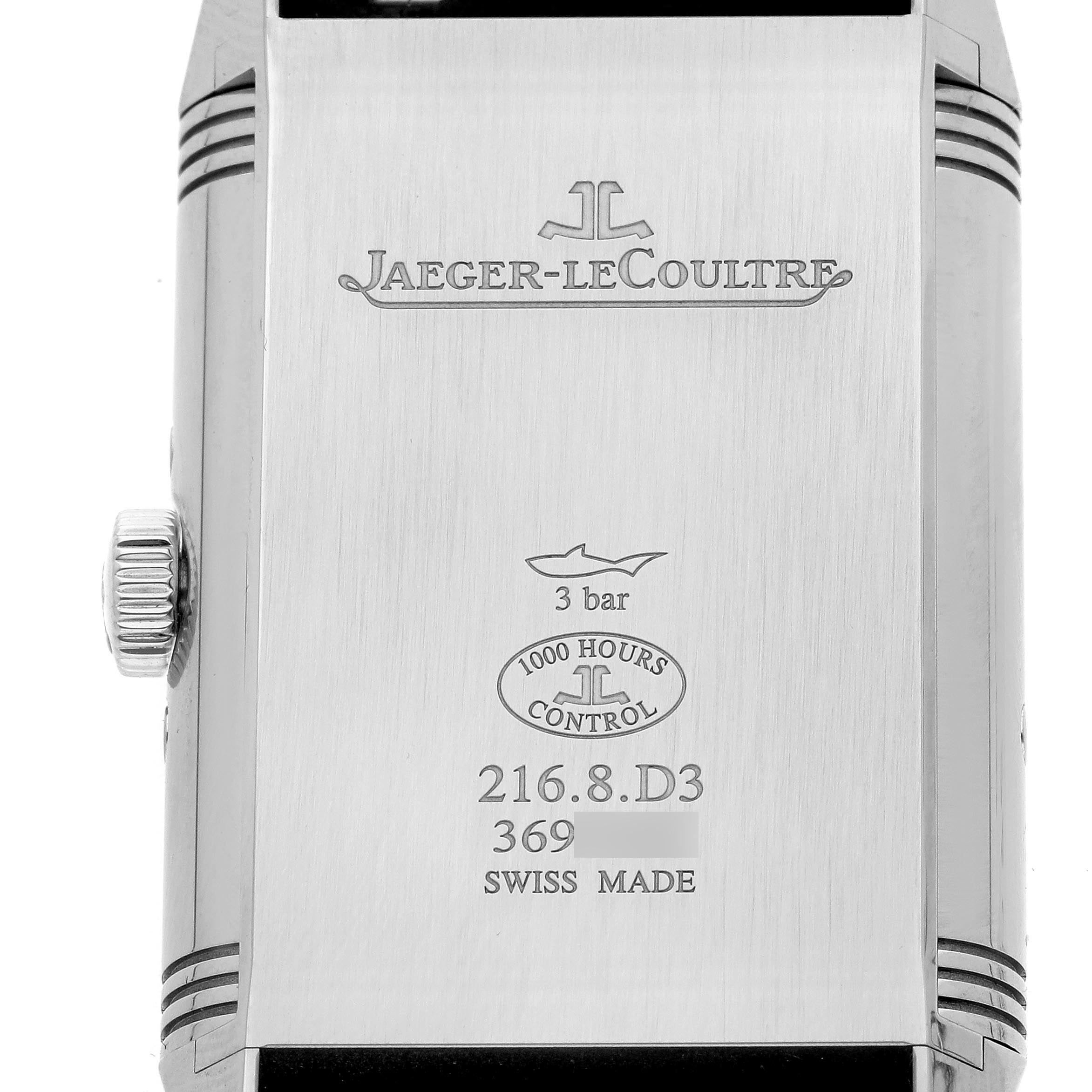 The image shows the back of a Jaeger-LeCoultre Reverso watch, highlighting its engraved branding and specifications.