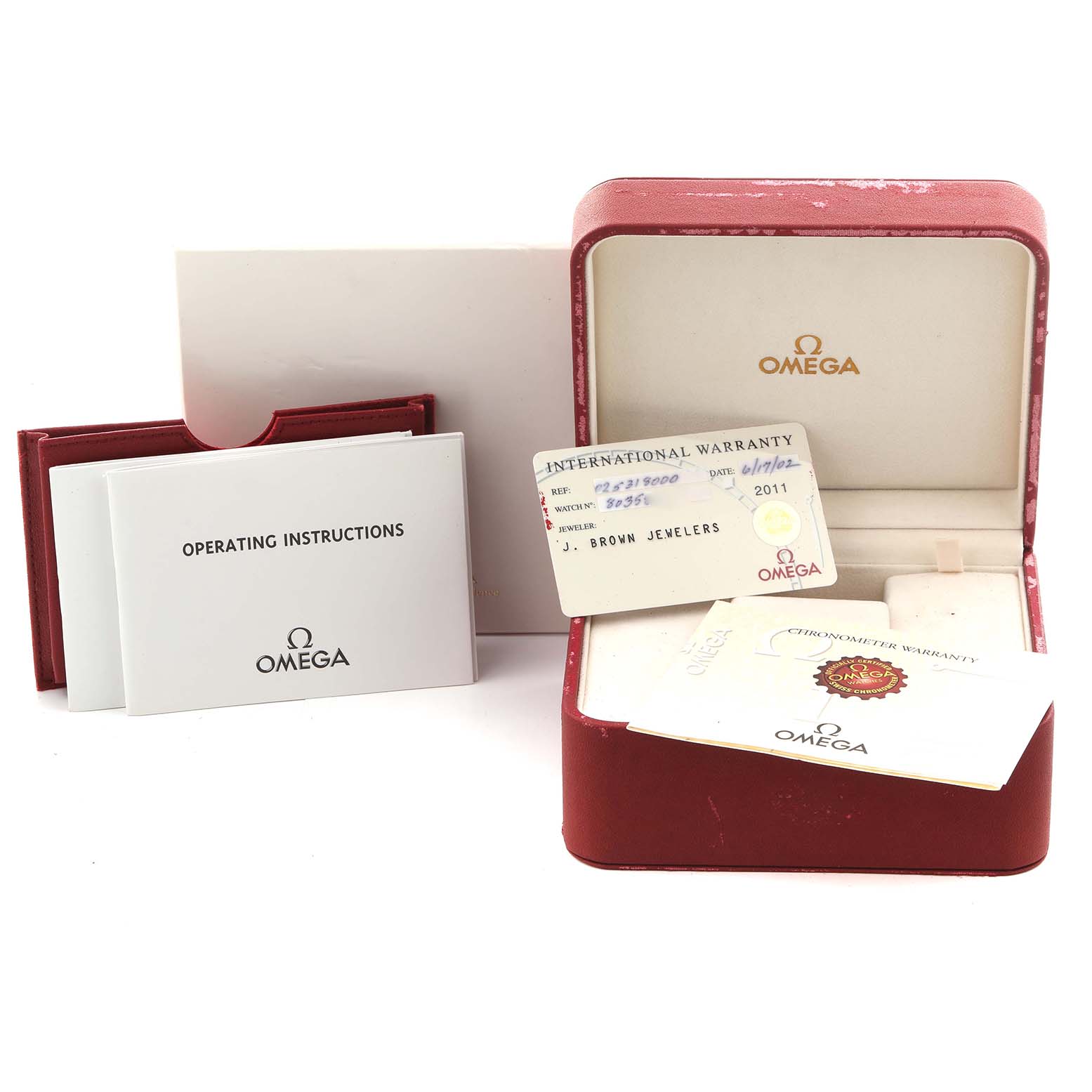 The image shows the Omega Seamaster 2531.80.00 Men
s Stainless Steel Blue Dial 2531.80.00 Men
s Stainless Steel Blue Dial accessories, including a warranty card, operating instructions, and a red watch box.