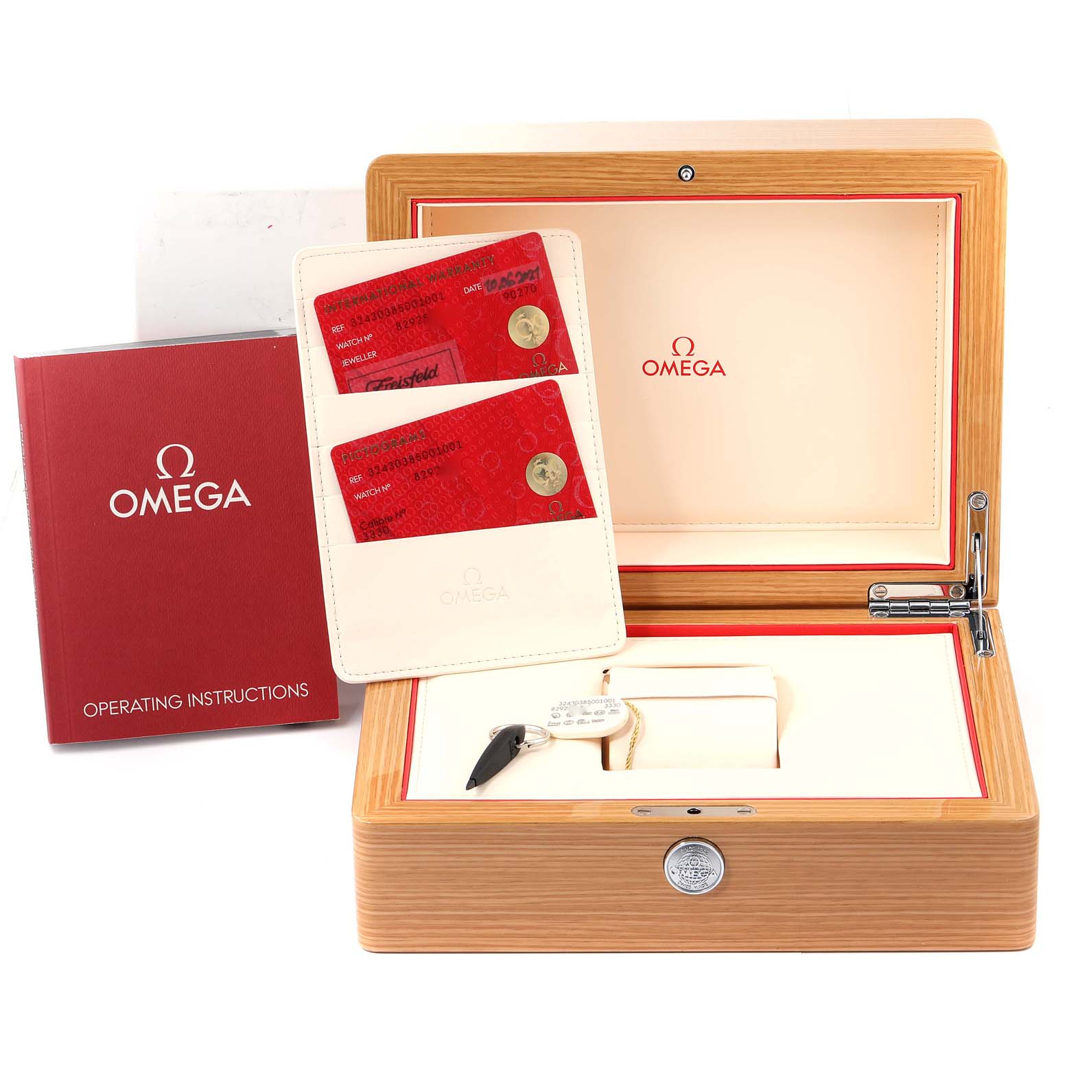 This image shows the open wooden box of an Omega Speedmaster 324.30.38.50.01.001 Men
s Stainless Steel Black Dial 324.30.38.50.01.001 Men
s Stainless Steel Black Dial watch, along with the instruction manuals and warranty cards.