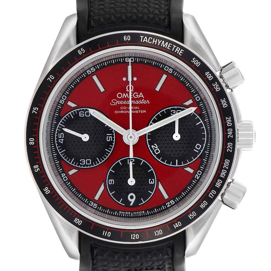 The Omega Speedmaster watch is shown from the front, highlighting the red dial, subdials, tachymetric scale, and black strap.