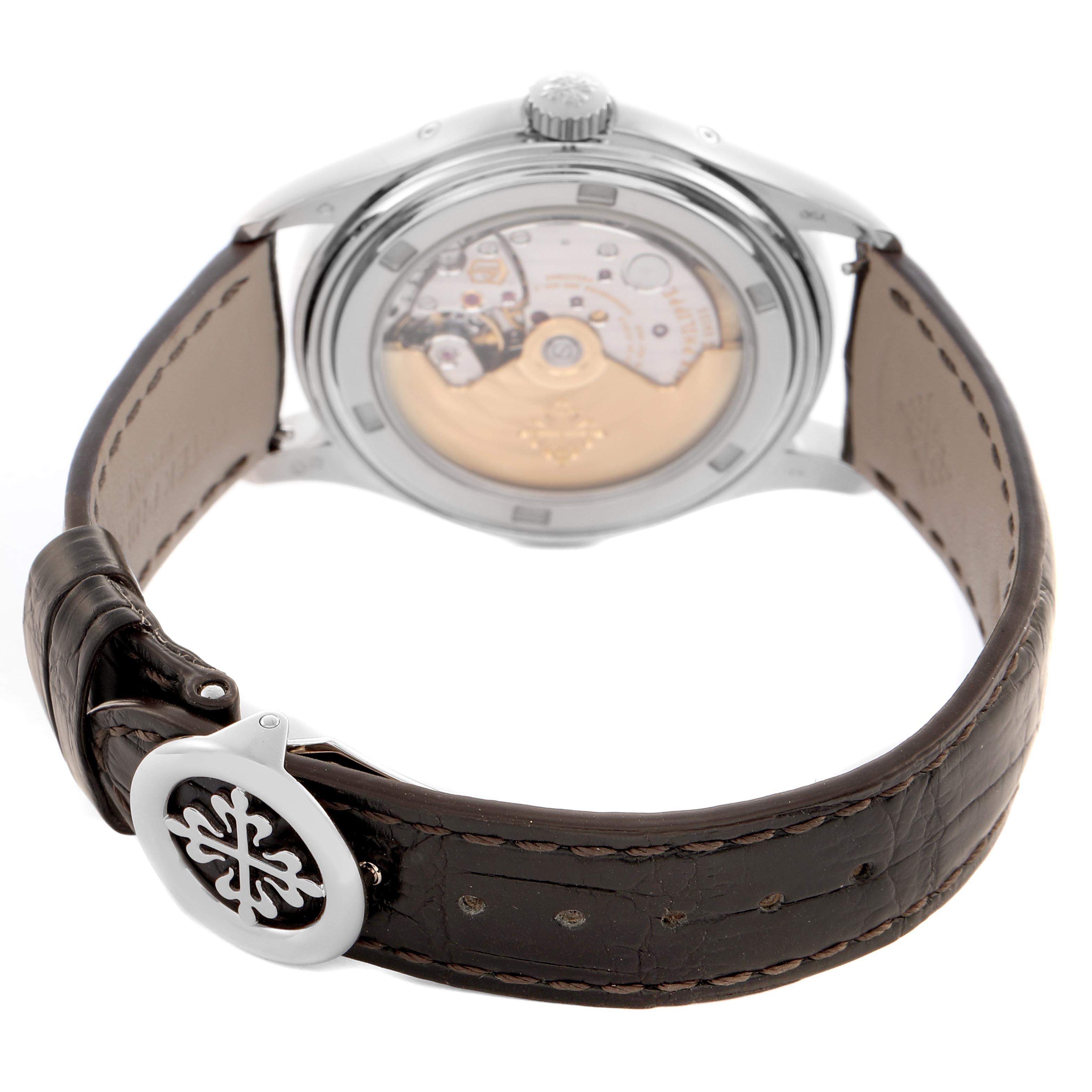 The image shows the back of a Patek Philippe Complications 5146G-010 Men
s White Gold Grey Dial 5146G-010 Men
s White Gold Grey Dial watch, focusing on the movement and leather strap with clasp.