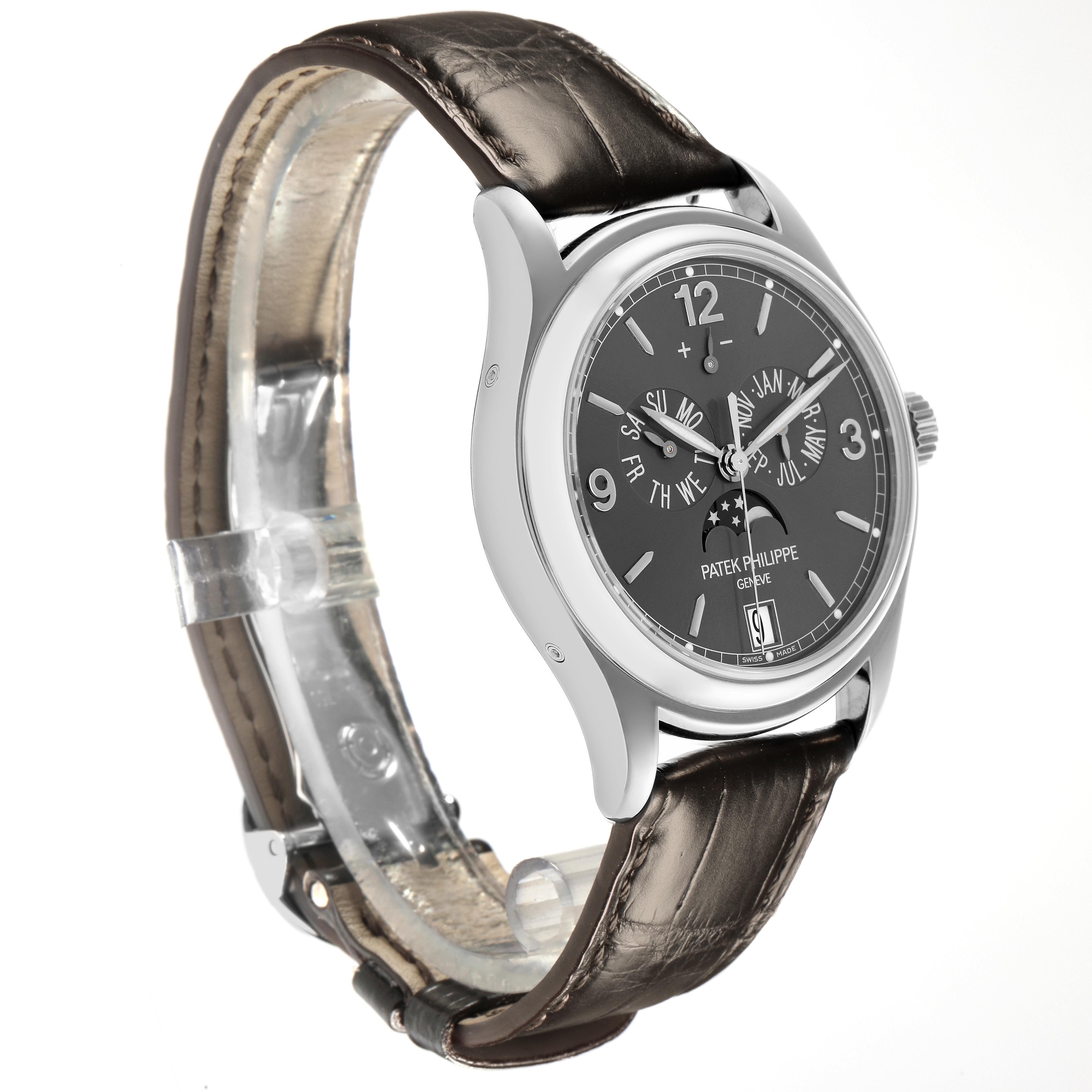 The Patek Philippe Complications 5146G-010 Men
s White Gold Grey Dial 5146G-010 Men
s White Gold Grey Dial watch is shown at a three-quarter angle, featuring its face, case, and leather strap.