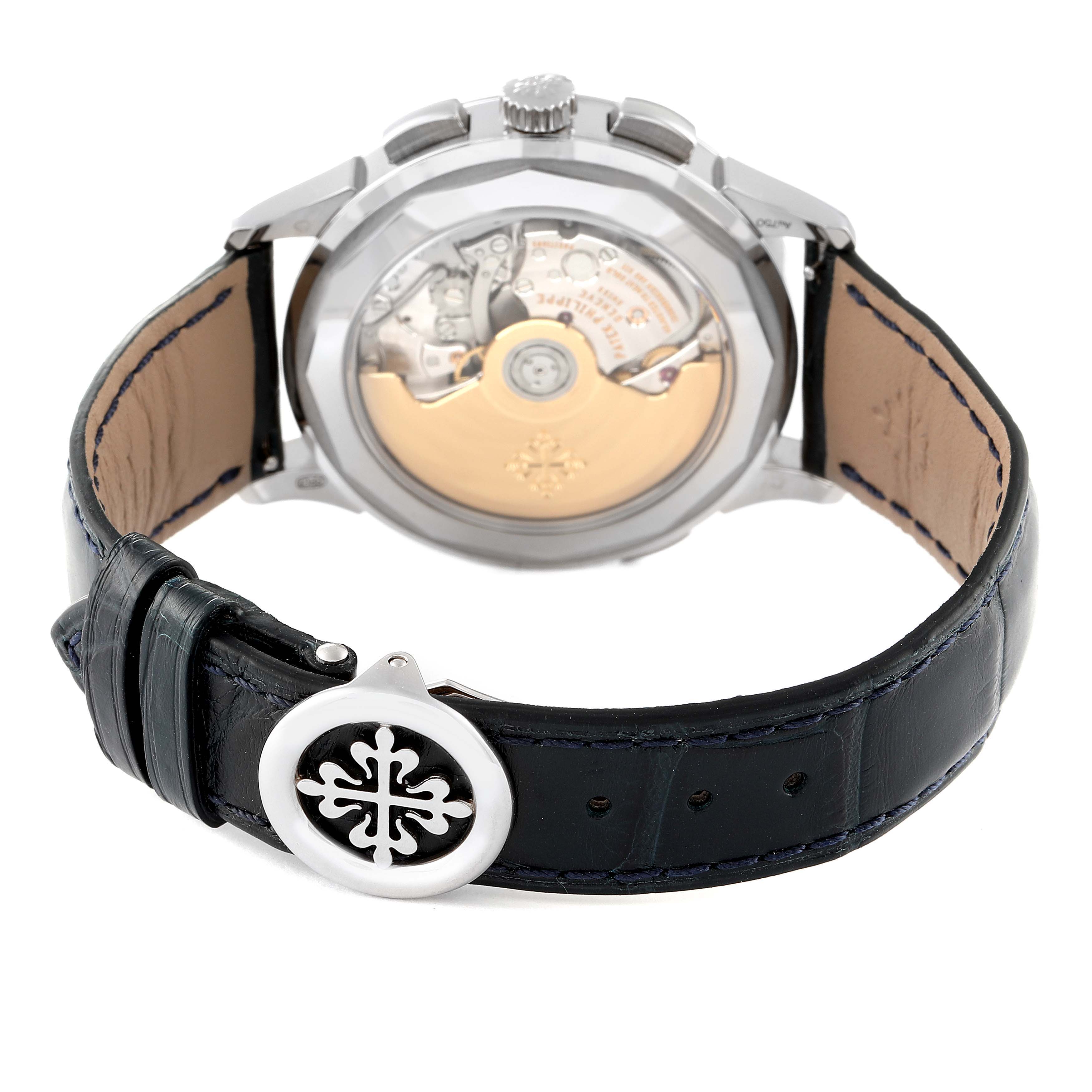 The image shows the back view of a Patek Philippe Complications 5930G-001 Men
s White Gold Blue Dial 5930G-001 Men
s White Gold Blue Dial watch, displaying the movement and the leather strap with a clasp.