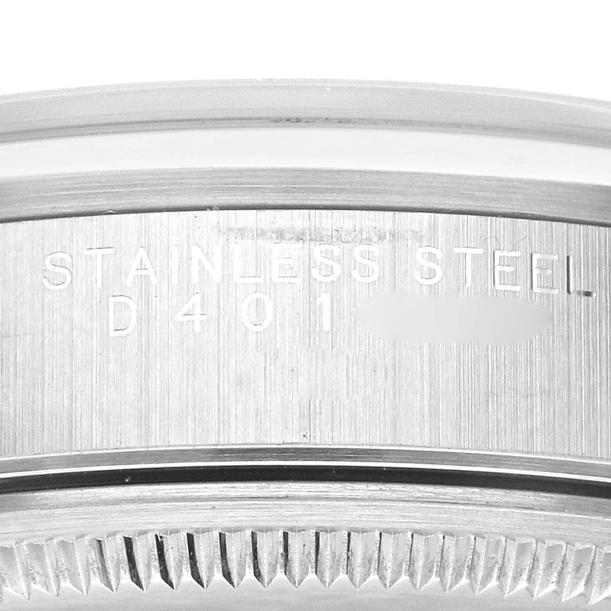 This image shows a close-up of the stainless steel case back where the serial number is partially visible on the Rolex Air-King 14000M Men's Stainless Steel Black Dial 14000M Men's Stainless Steel Black Dial watch.