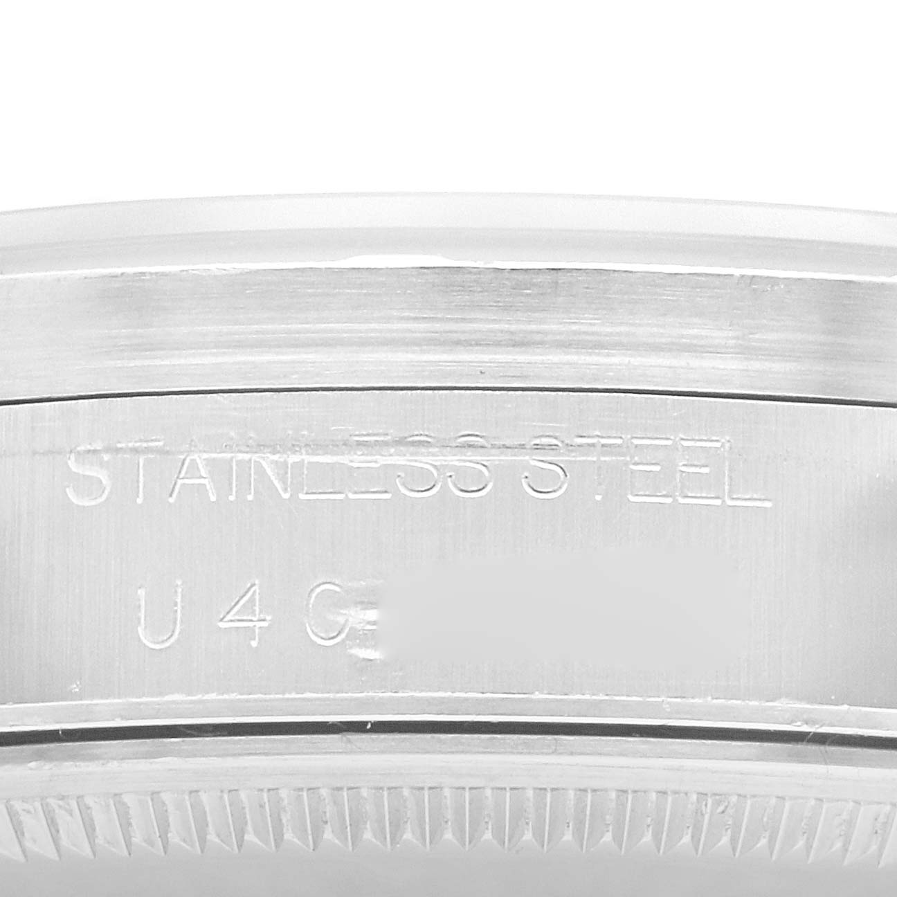 The image shows a close-up of the side of a Rolex Air-King 14010 Men's Stainless Steel Black Dial 14010 Men's Stainless Steel Black Dial watch, highlighting the stainless steel case and engraved text.