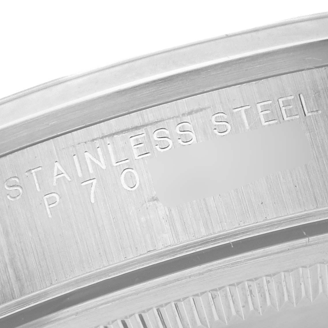 This is a close-up view of the stainless steel case back of the Rolex Air-King 14000 Men's Stainless Steel Silver Dial 14000 Men's Stainless Steel Silver Dial watch, showing part of its engraved text.