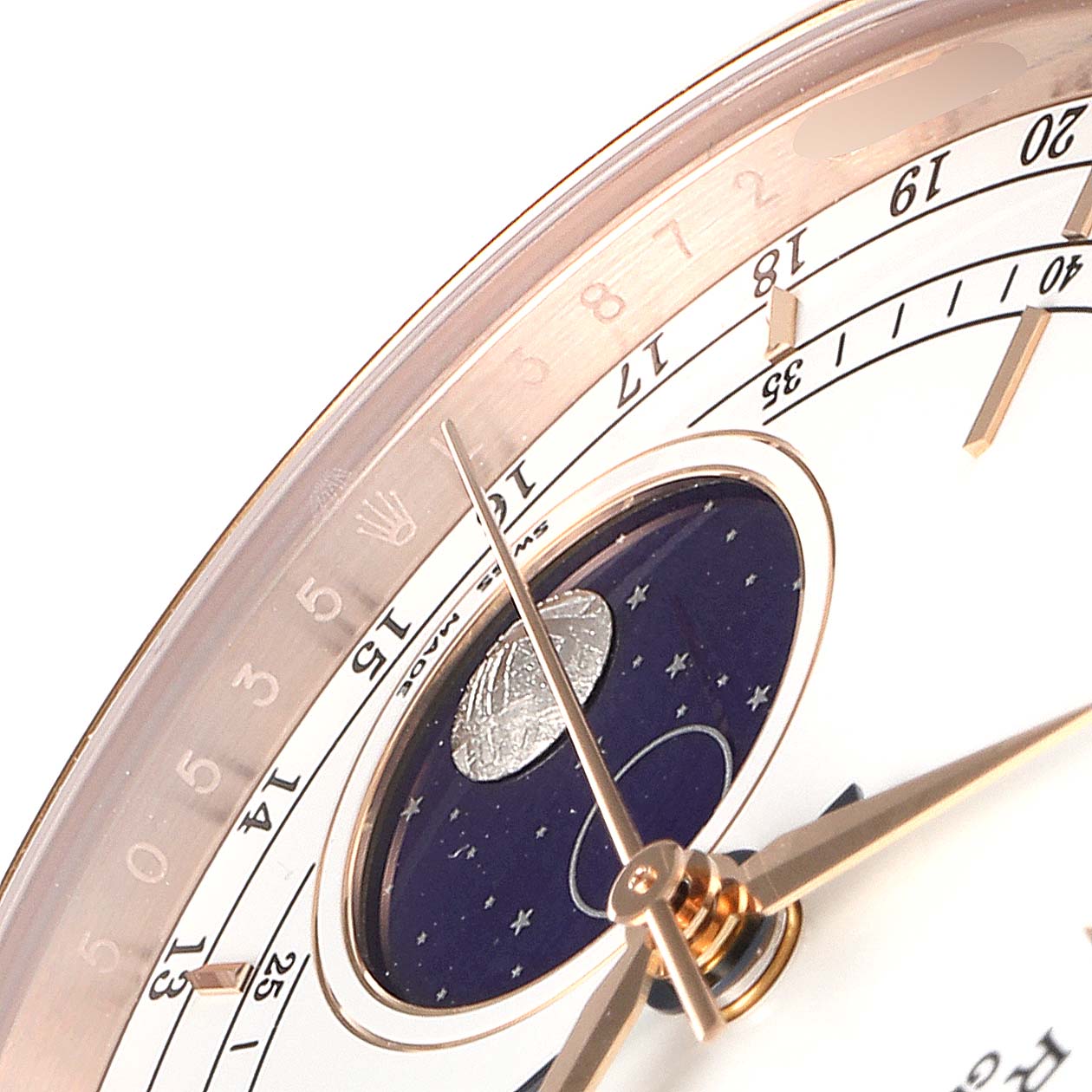 A close-up angle of the Rolex Cellini 50535 Men
s Rose Gold White Dial 50535 Men
s Rose Gold White Dial showing the hands, part of the bezel, and the moonphase display.