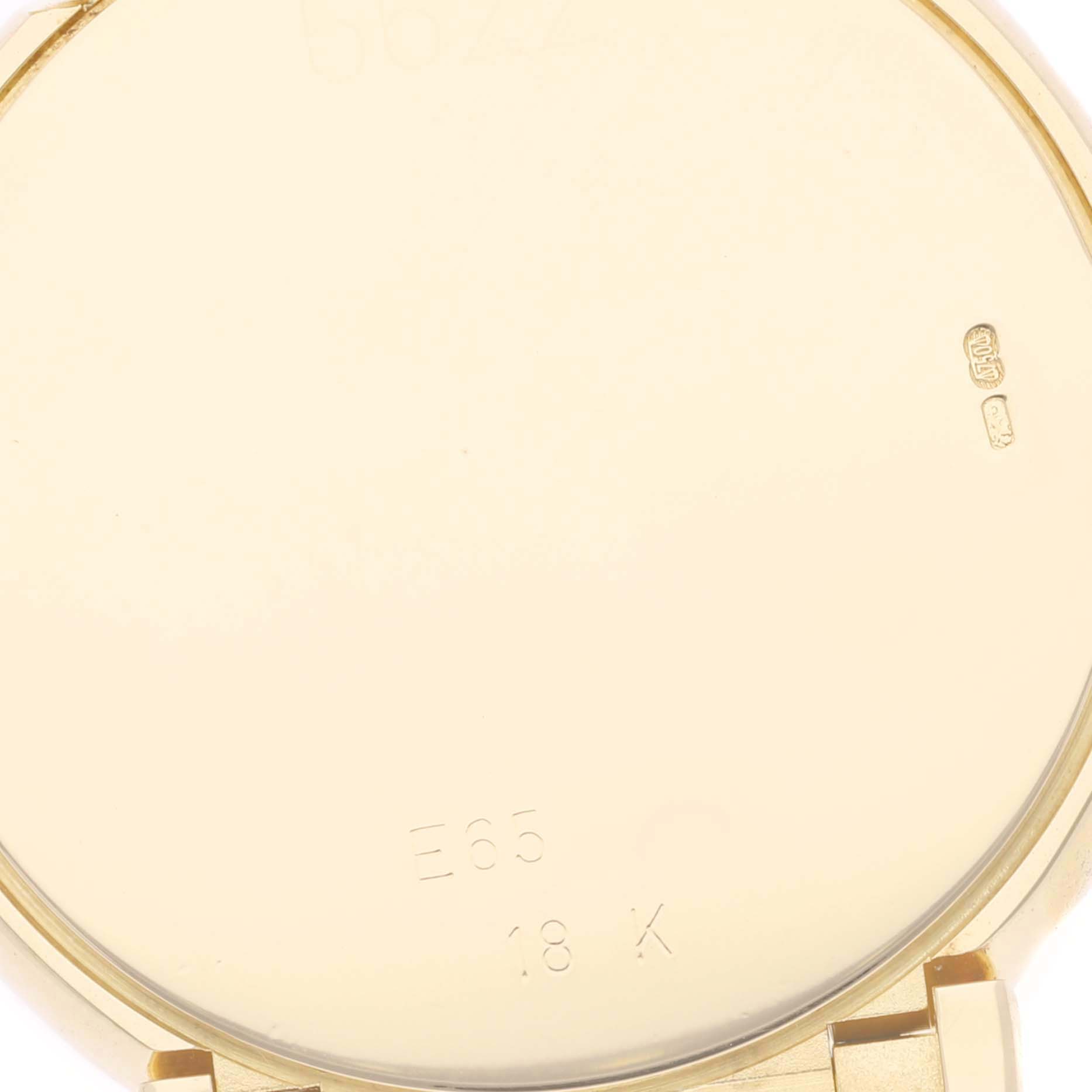 This image shows the inside caseback of a Rolex Cellini 6622 Men's Yellow Gold Champagne Dial 6622 Men's Yellow Gold Champagne Dial watch, engraved with "E65" and "18 K."
