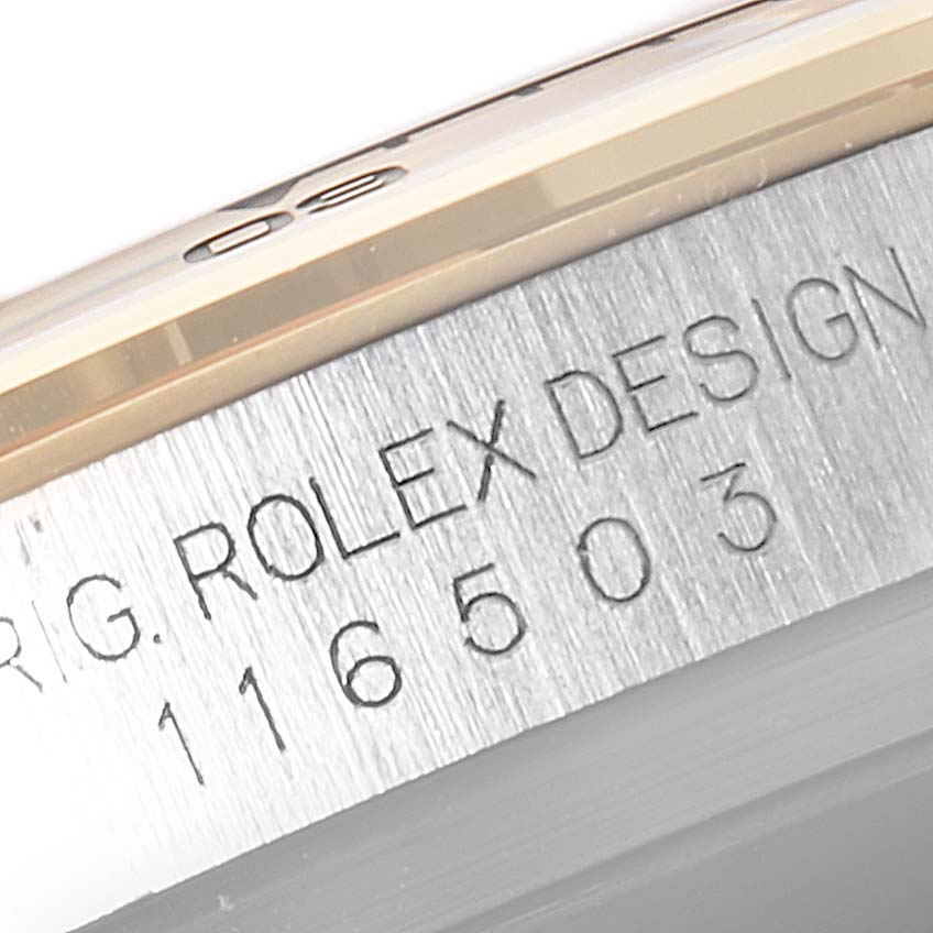 This image shows a close-up angle of the side of a Rolex Daytona 116503 Men's Steel and Gold (two tone) Champagne Dial 116503 Men's Steel and Gold (two tone) Champagne Dial watch case, displaying the engraved model number and "ROLEX DESIGN."