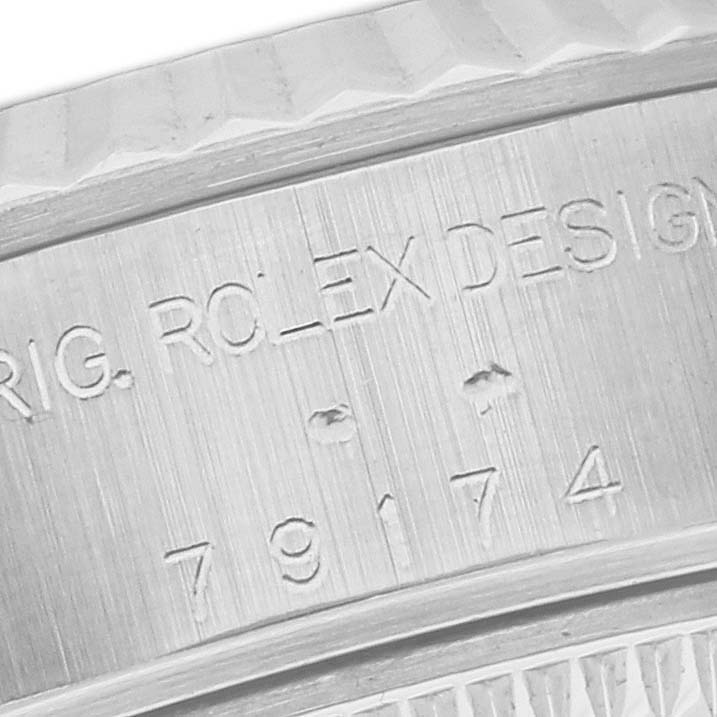 This close-up image shows the engraved model number and part of the bezel of a Rolex Datejust 79174 Women's Stainless Steel Silver Dial 79174 Women's Stainless Steel Silver Dial watch.