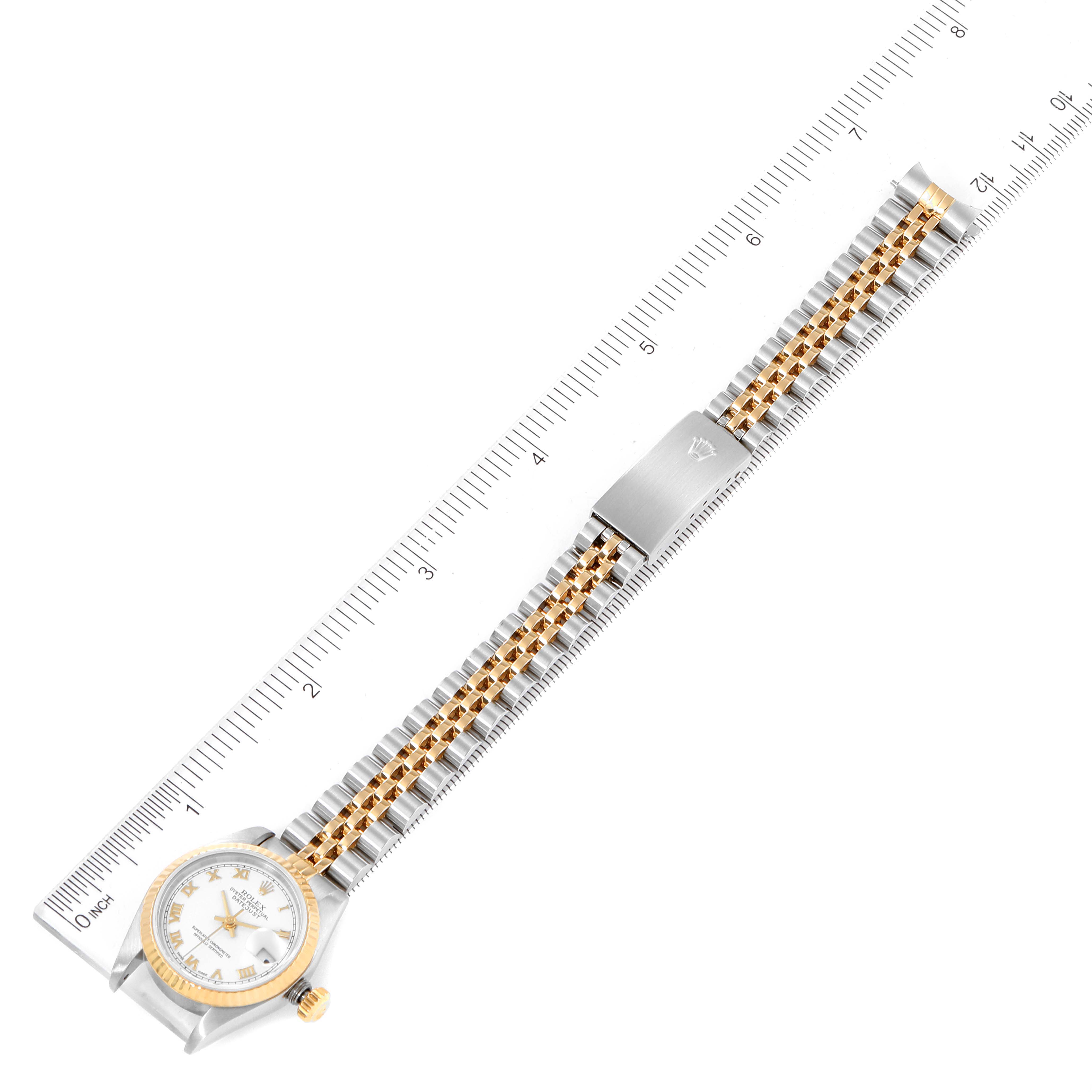 This image shows aerial view of a Rolex Datejust 79173 Women's Steel and Gold (two tone) White Dial 79173 Women's Steel and Gold (two tone) White Dial watch with the face, bezel, crown, clasp, and bracelet visible.