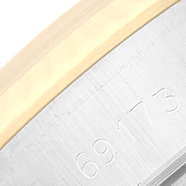 This close-up image shows part of the bezel and the case side with engraved numbers on the Rolex Datejust 69173 Women's Steel and Gold (two tone) Black Dial 69173 Women's Steel and Gold (two tone) Black Dial watch.