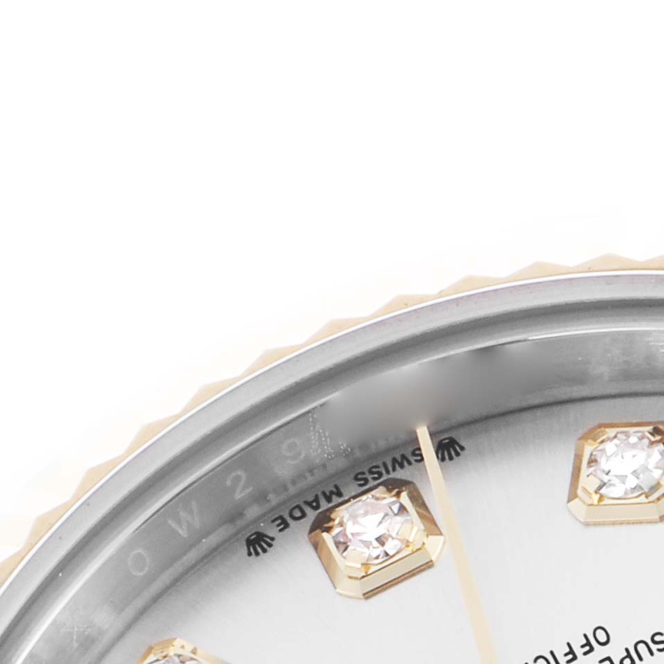 The image shows a close-up of the Rolex Datejust dial, focusing on diamond hour markers and part of the bezel.