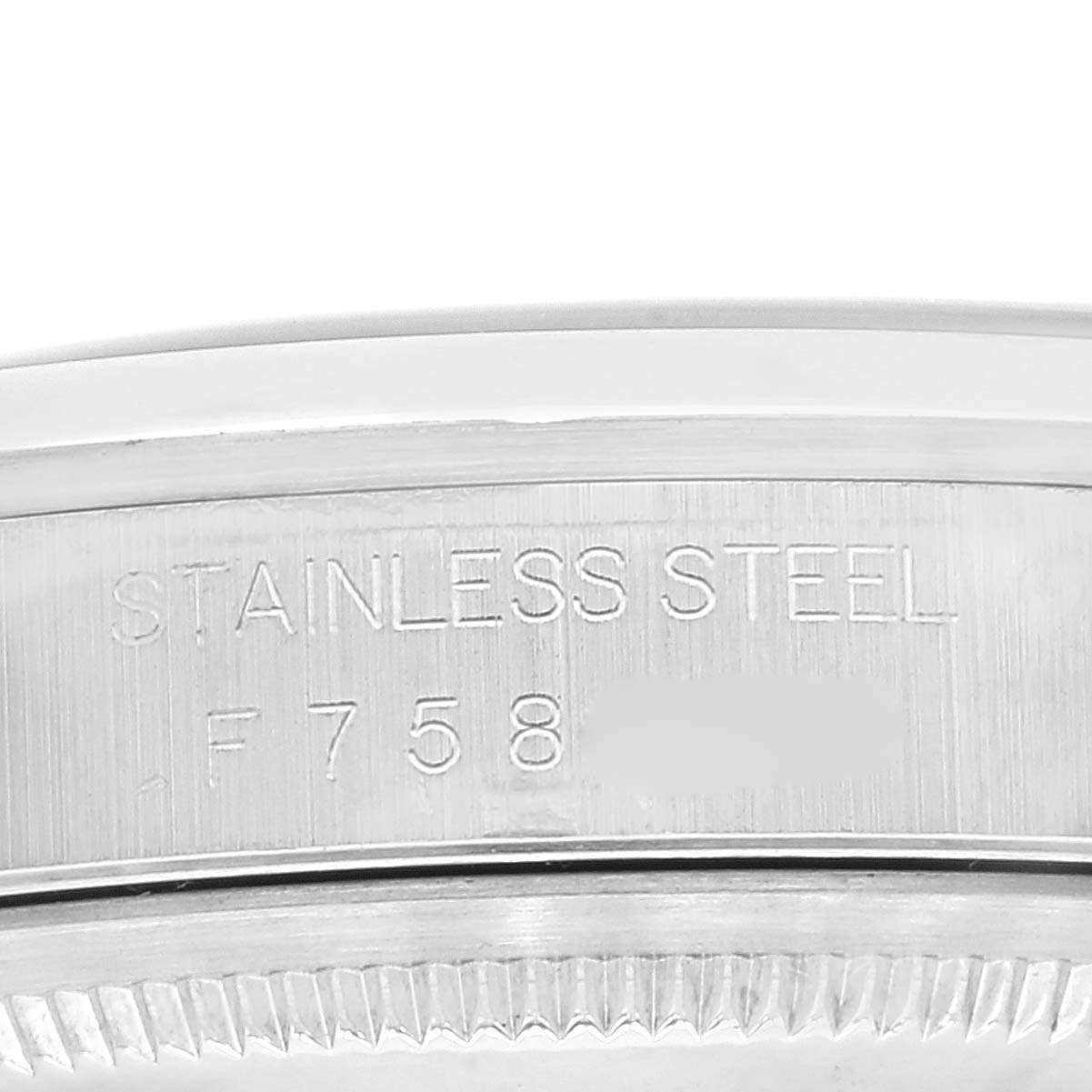 This image shows a close-up of the engraved serial number and "STAINLESS STEEL" text on the case back of a Rolex Datejust 16200 Men's Stainless Steel Black Dial 16200 Men's Stainless Steel Black Dial watch.