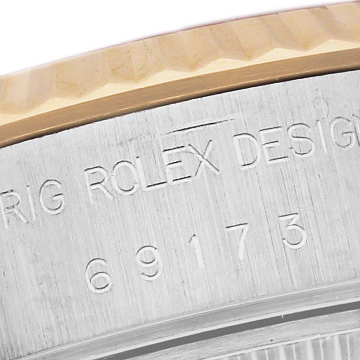 The image shows a close-up of the engraved side of a Rolex Datejust 69173 Women's Steel and Gold (two tone) Champagne Dial 69173 Women's Steel and Gold (two tone) Champagne Dial watch, displaying part of the model number and bezel.