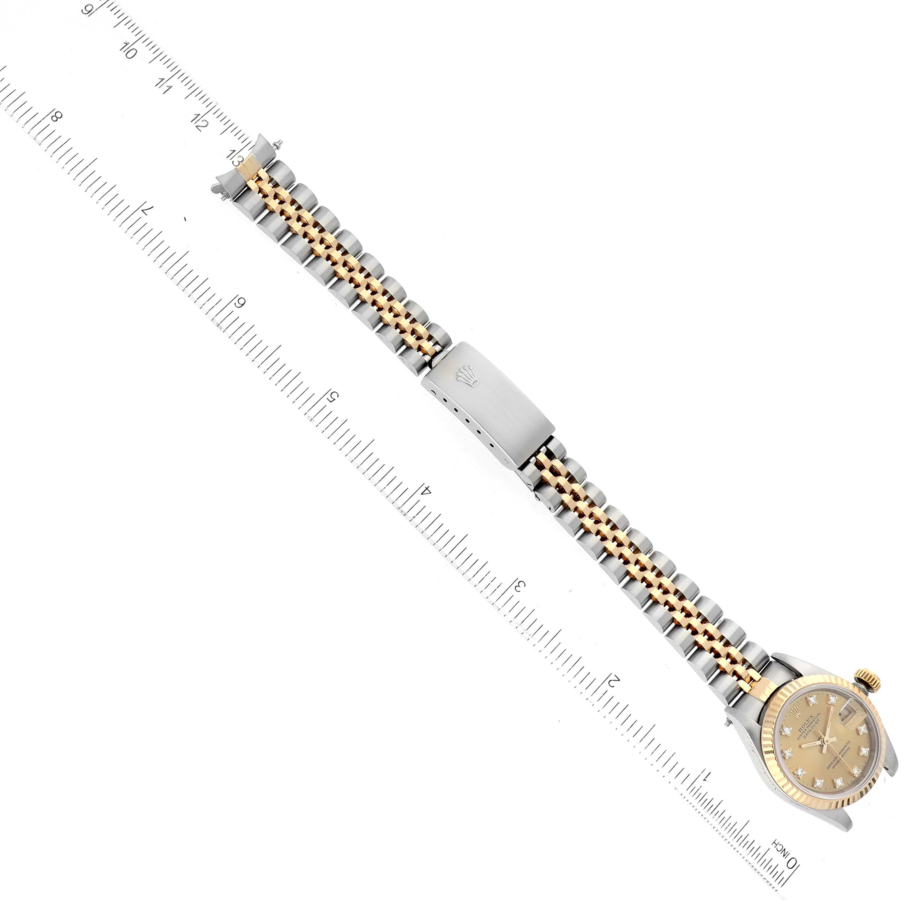 The image shows a Rolex Datejust 69173 Women's Steel and Gold (two tone) Champagne Dial 69173 Women's Steel and Gold (two tone) Champagne Dial watch laid flat next to a ruler, displaying the full watch, bracelet, and clasp from an overhead angle.
