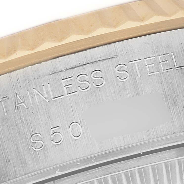 This close-up shows the stainless steel case back of a Rolex Datejust 69173 Women's Steel and Gold (two tone) Champagne Dial 69173 Women's Steel and Gold (two tone) Champagne Dial watch with part of the fluted bezel visible.