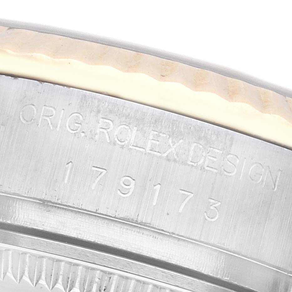 The image shows a close-up of a Rolex Datejust 179173 Women
s Steel and Gold (two tone) Black Dial 179173 Women
s Steel and Gold (two tone) Black Dial model
s watch case edge, highlighting the engraved model number.