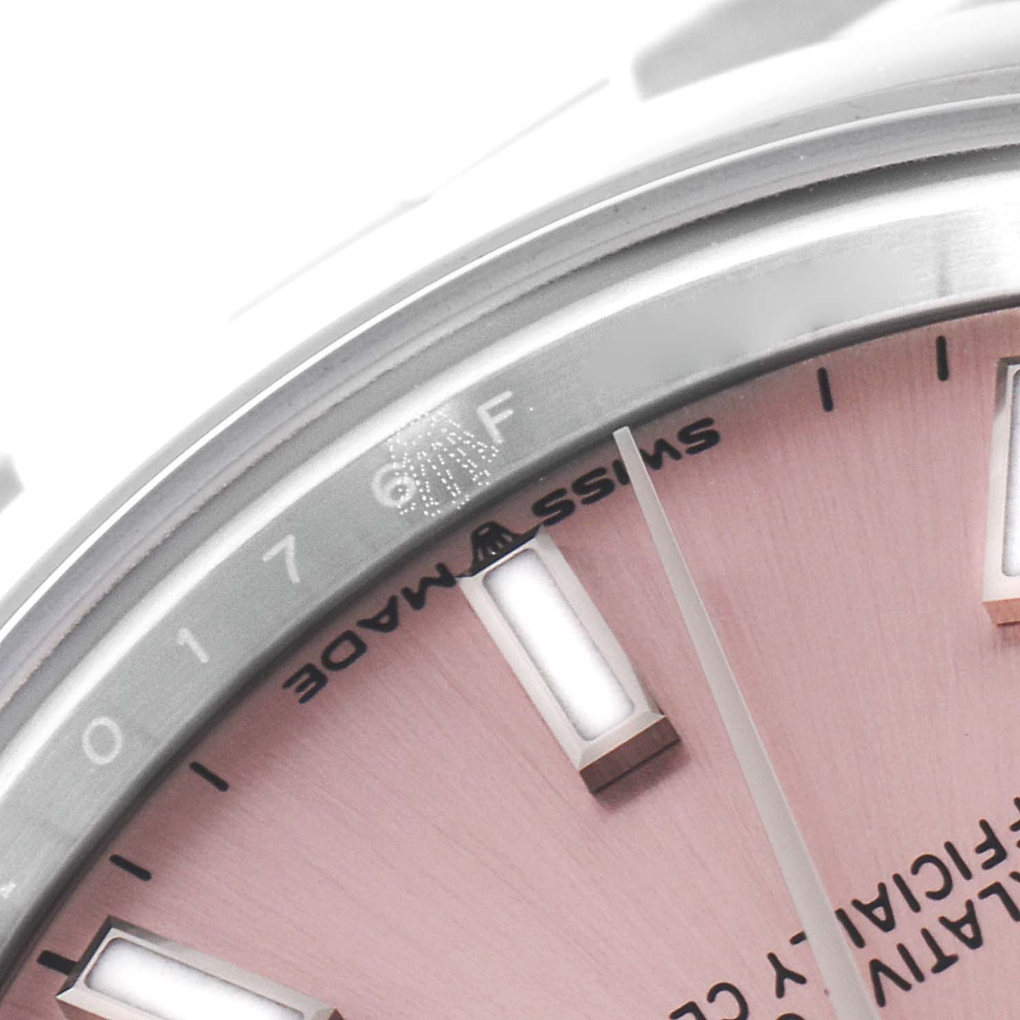 The image shows a close-up of the dial and a portion of the bezel of a Rolex Mid-Size 278240 Women
s Stainless Steel Pink Dial 278240 Women
s Stainless Steel Pink Dial watch.