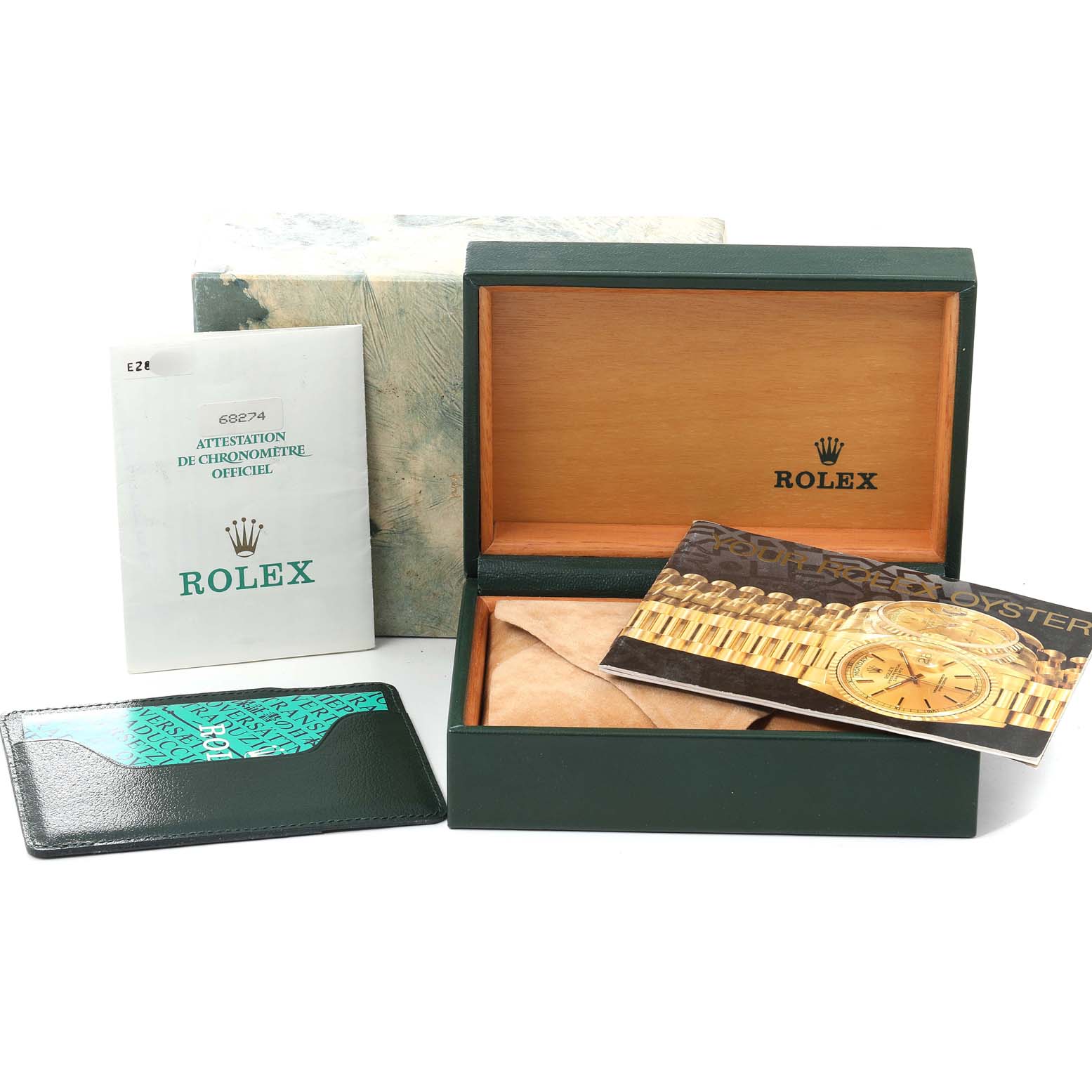 The image displays the accessories of a Rolex Mid-Size 68274 Women
s Stainless Steel Silver Dial 68274 Women
s Stainless Steel Silver Dial model, including its box, manuals, and warranty card holder.