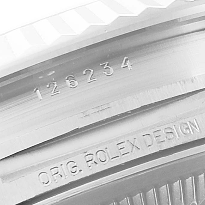 This close-up shows the serial number and "ORIG. ROLEX DESIGN" engraving on the inner bezel of a Rolex Datejust 126234 Men's Stainless Steel Purple Dial 126234 Men's Stainless Steel Purple Dial model watch.