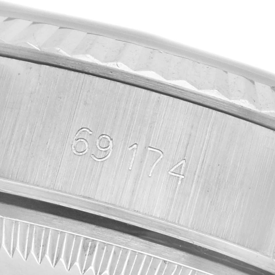 The image shows a close-up of the serial number engraved on the case side of a Rolex Datejust 69174 Women
s Stainless Steel Silver Dial 69174 Women
s Stainless Steel Silver Dial watch.
