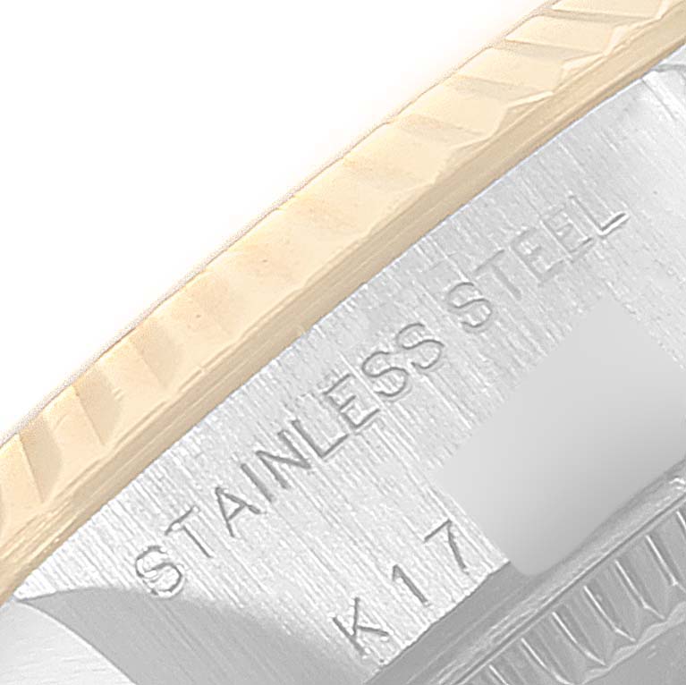 This close-up image shows the "Stainless Steel" engraving on the side of the Rolex Datejust 79173 Women
s Steel and Gold (two tone) Champagne Dial 79173 Women
s Steel and Gold (two tone) Champagne Dial watch case.