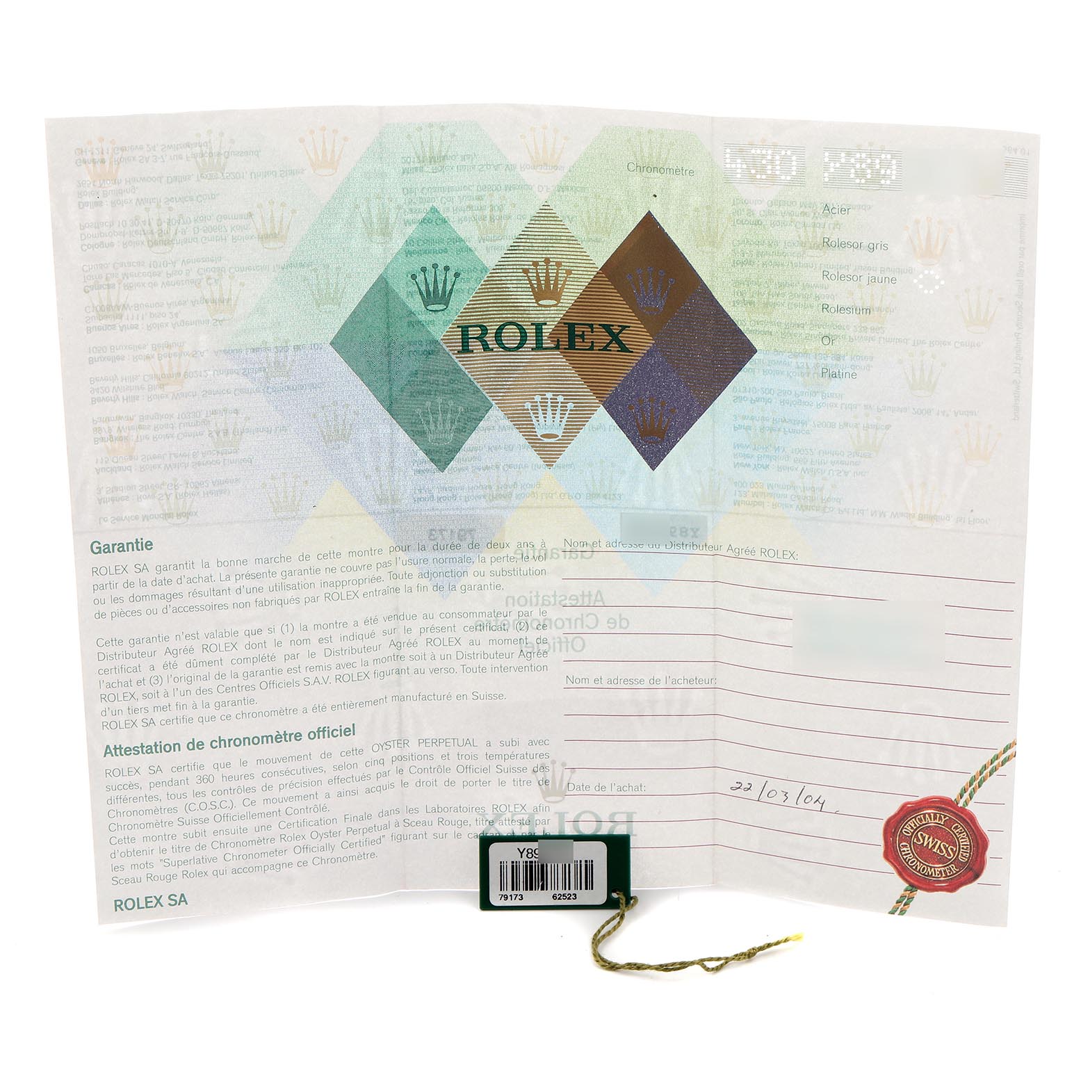 The image shows a Rolex Datejust 79173 Women
s Steel and Gold (two tone) Champagne Dial 79173 Women
s Steel and Gold (two tone) Champagne Dial warranty card and pamphlet with a green tag attached.