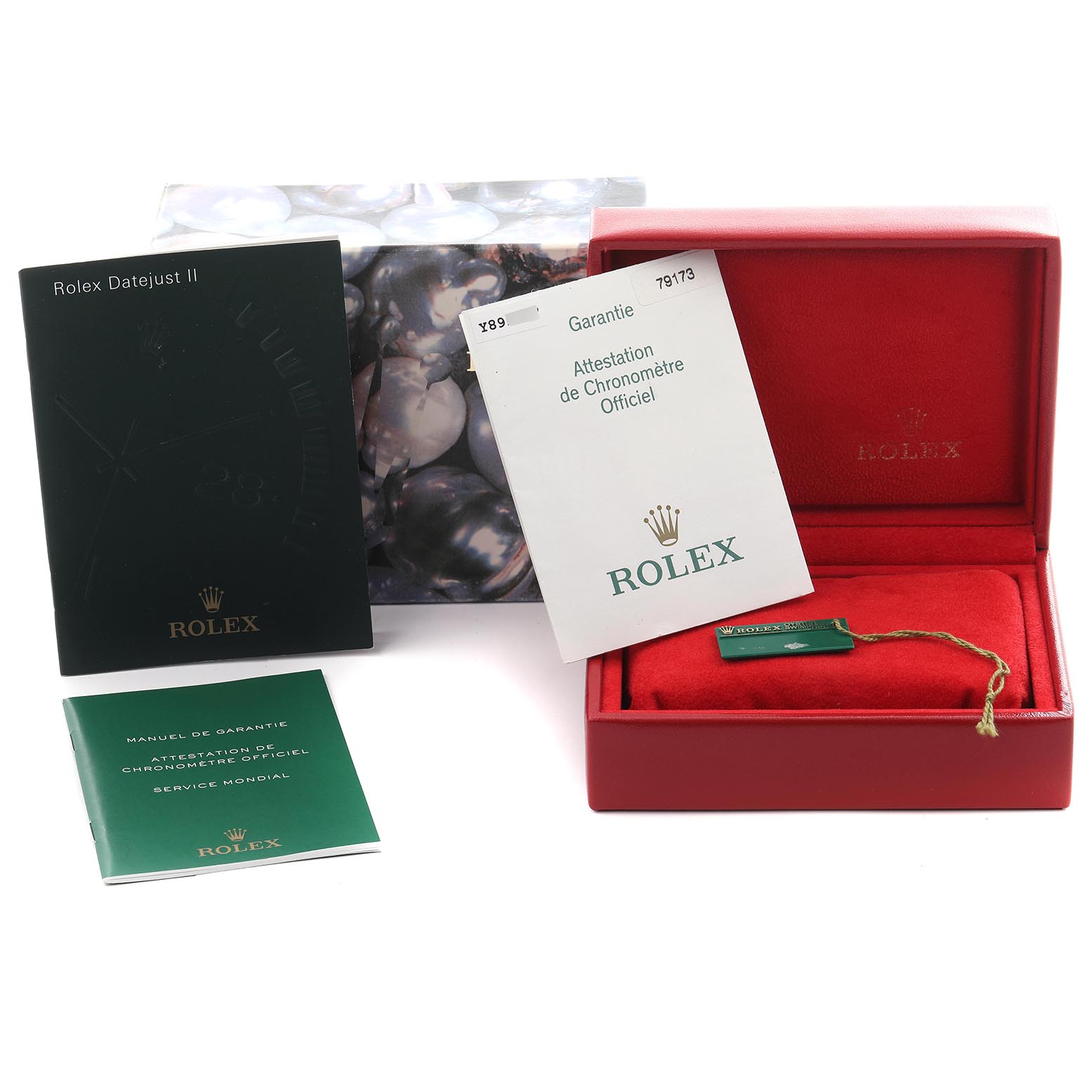 The image shows Rolex Datejust 79173 Women
s Steel and Gold (two tone) Champagne Dial 79173 Women
s Steel and Gold (two tone) Champagne Dial accessories, including booklets, a box, and a tag, without the watch.