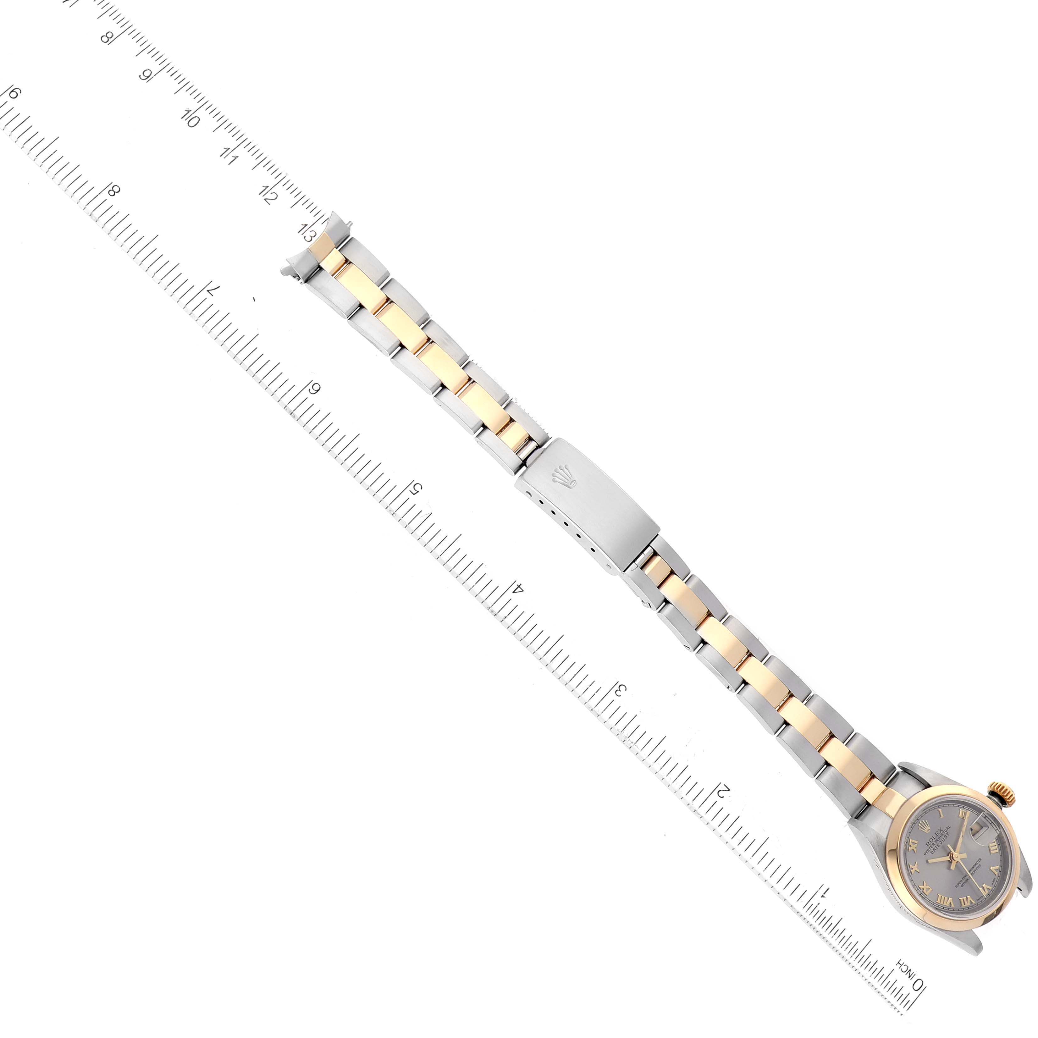 The image shows a top-down view of a Rolex Datejust 79163 Women's Steel and Gold (two tone) Grey Dial 79163 Women's Steel and Gold (two tone) Grey Dial watch with its band fully extended alongside a ruler for scale.