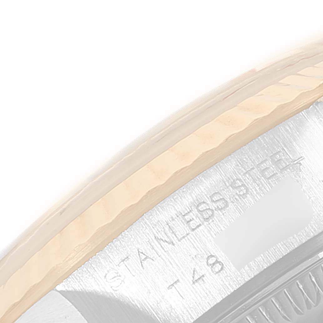 The image shows an extreme close-up of the bezel and casing of a Rolex Datejust 69173 Women's Steel and Gold (two tone) White Dial 69173 Women's Steel and Gold (two tone) White Dial watch, highlighting the "STAINLESS STEEL" engraving.