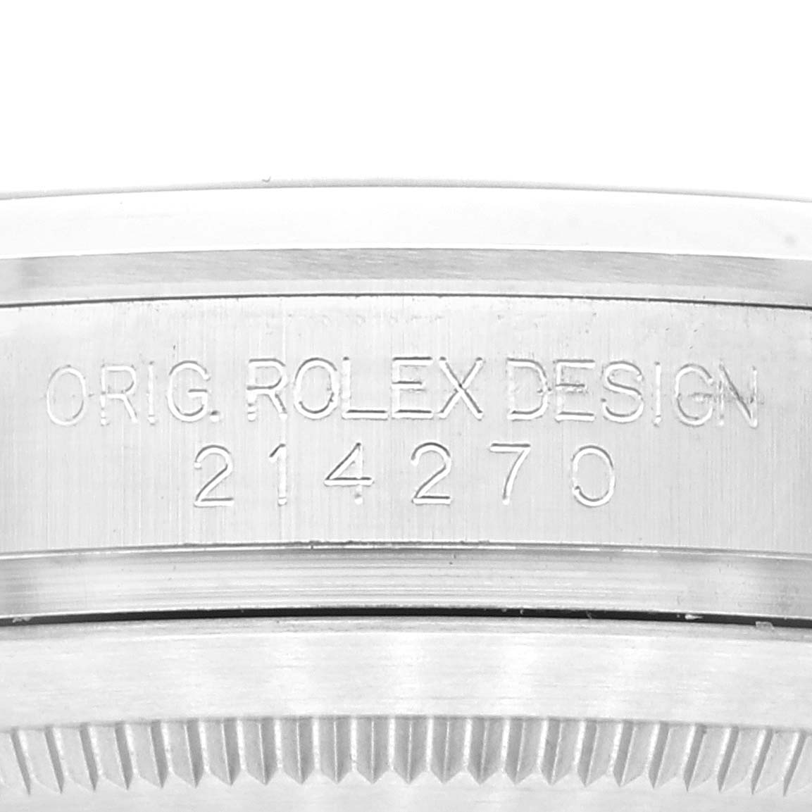 This close-up image of the Rolex Explorer 214270 Men's Stainless Steel Black Dial 214270 Men's Stainless Steel Black Dial watch shows part of the case with the engraved model number "214270" and the inscription "ORIG. ROLEX DESIGN."